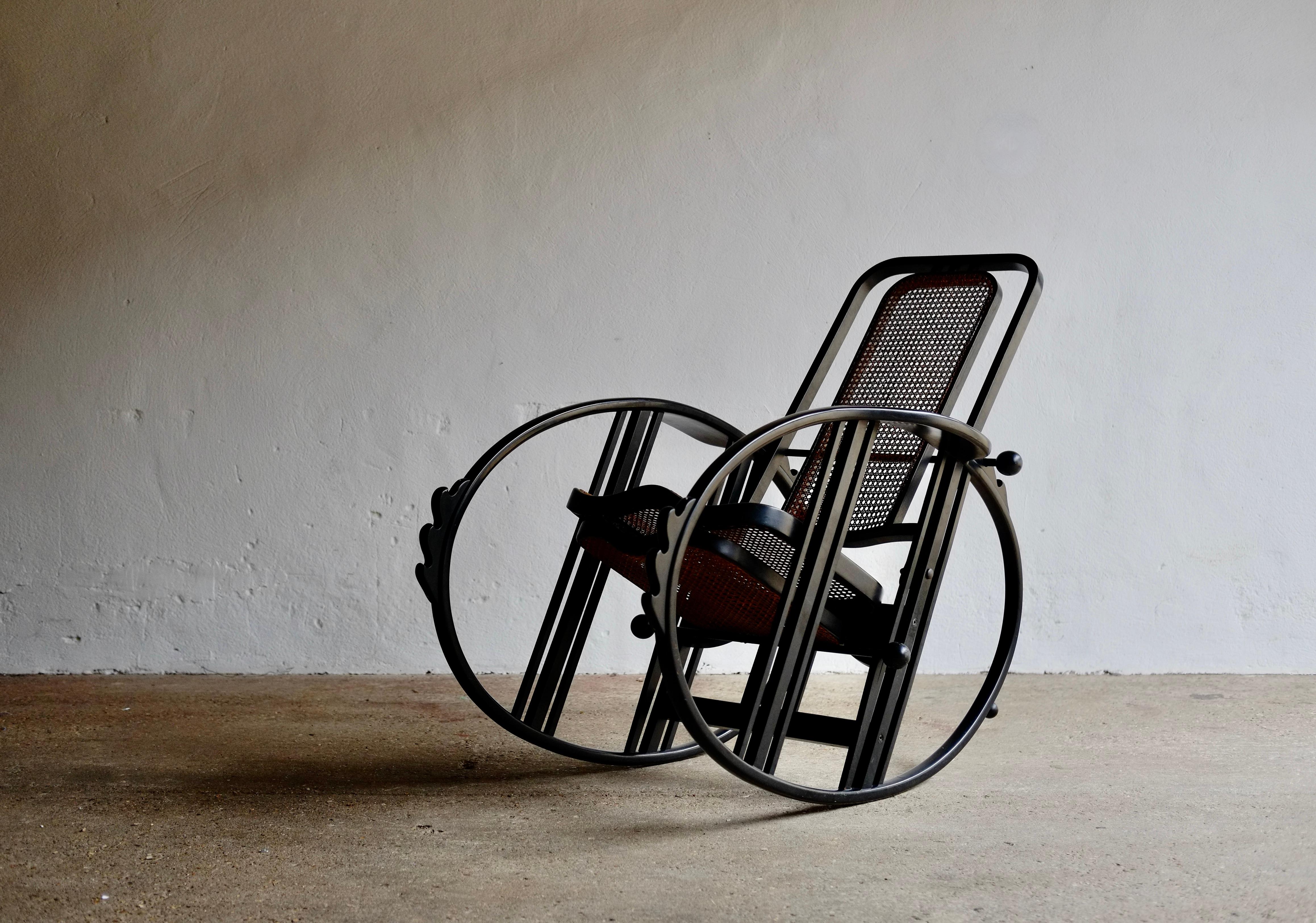 A rare No. 267 egg rocking chair designed by Josef Hoffmann in 1922 and produced in a limited run by Societa Anonima Antonio Volpe in Udine, Italy circa 1980.
Black lacquered beech bentwood and viennese woven rattan, multi-adjustable backrest and
