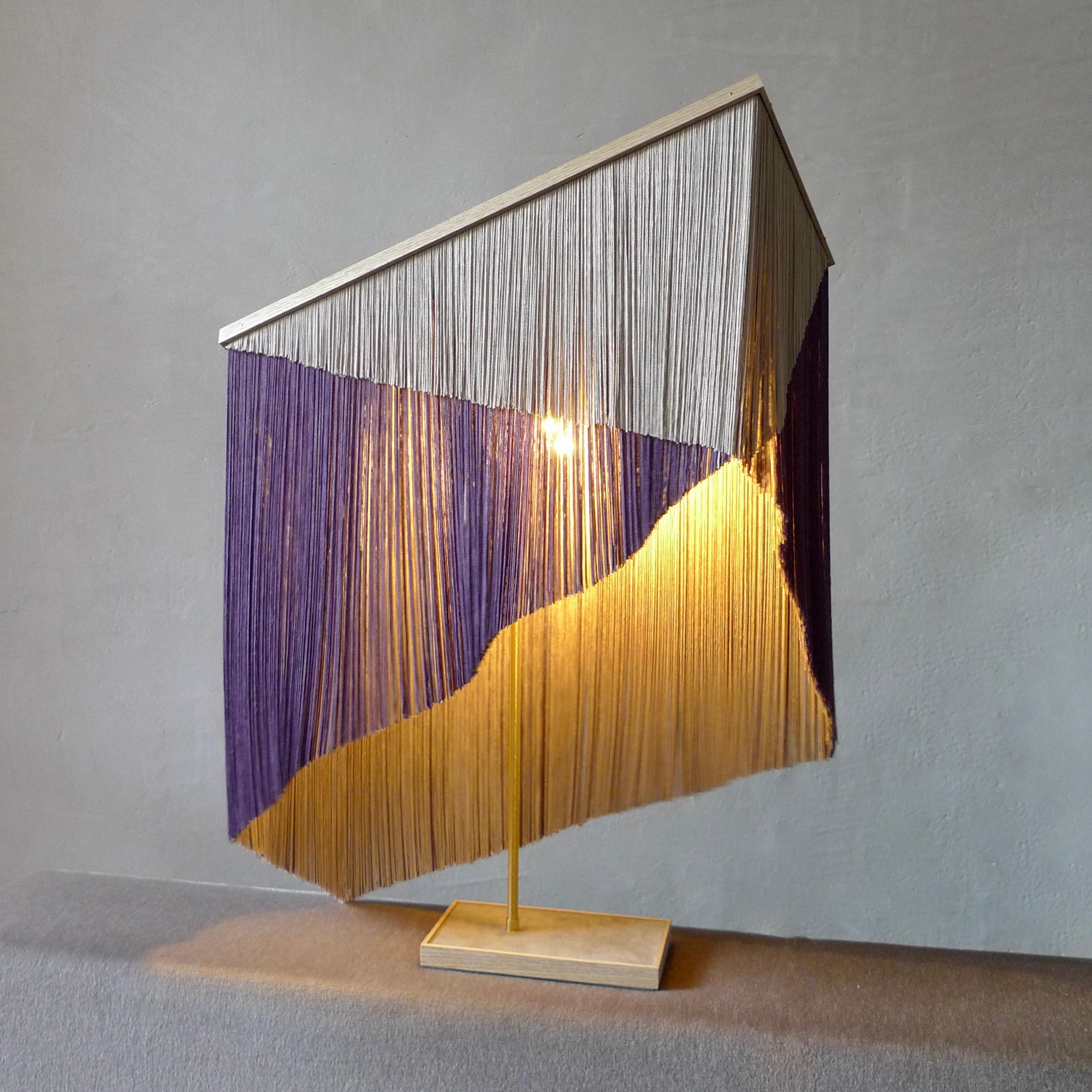 No. 30 table lamp by Sander Bottinga
Object size 4
Dimensions: H 73 x W 38 x D 25 cm
Materials: Brass, Wood, Leather, Viscose Fringes
Variations available.

Handmade in brass, wood, leather and 3 double layered viscose fringes in geometric cut and