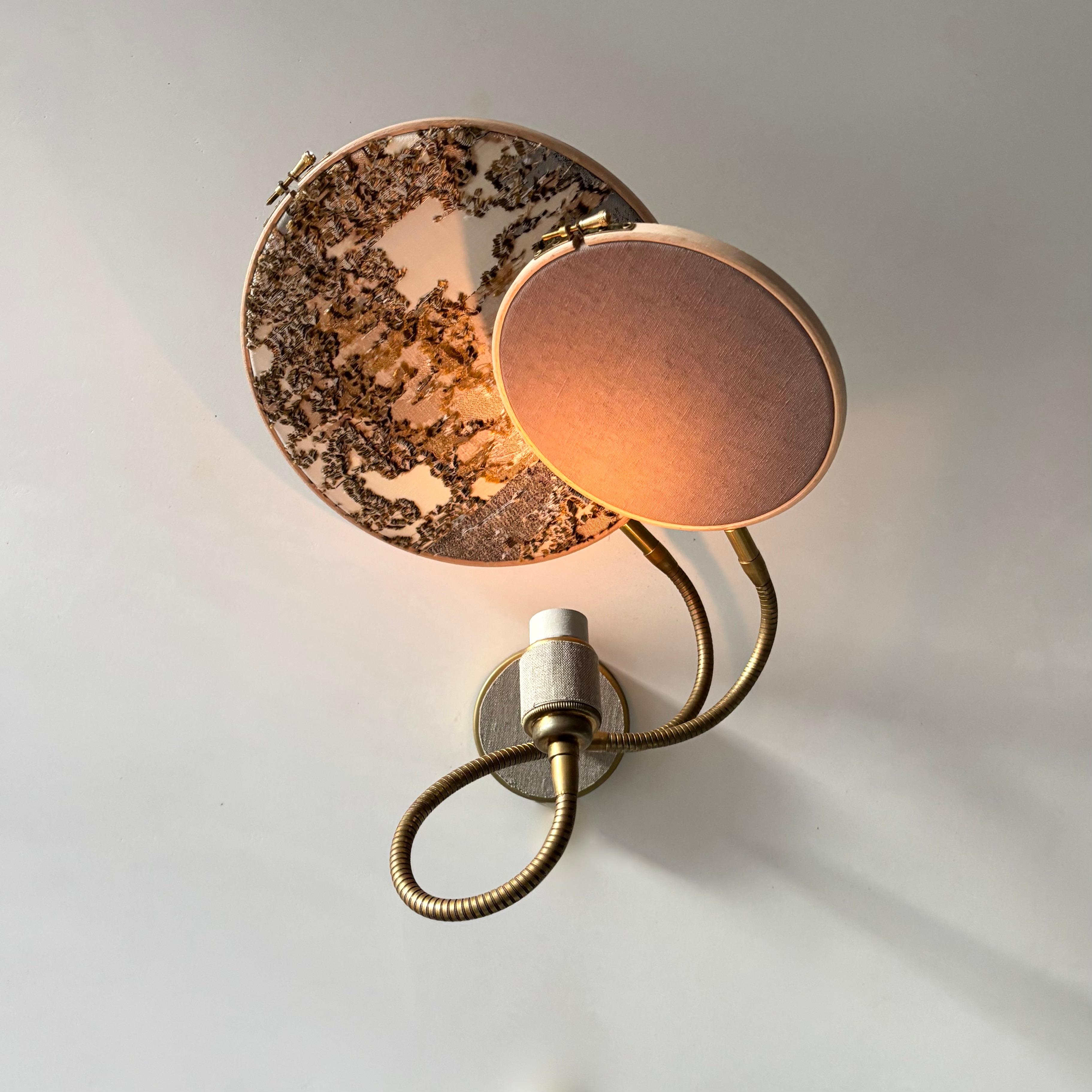 No. 33 Wall Lamp, 2 Circles, by Sander Bottinga
Dimensions: D 25 cm x W 38 cm x H 40 cm
Materials: brass, wood, stone color hand-painted linen, marble embroidered design in silk, viscose, cotton.

Available with 2 circles or 1 circle.
Available in