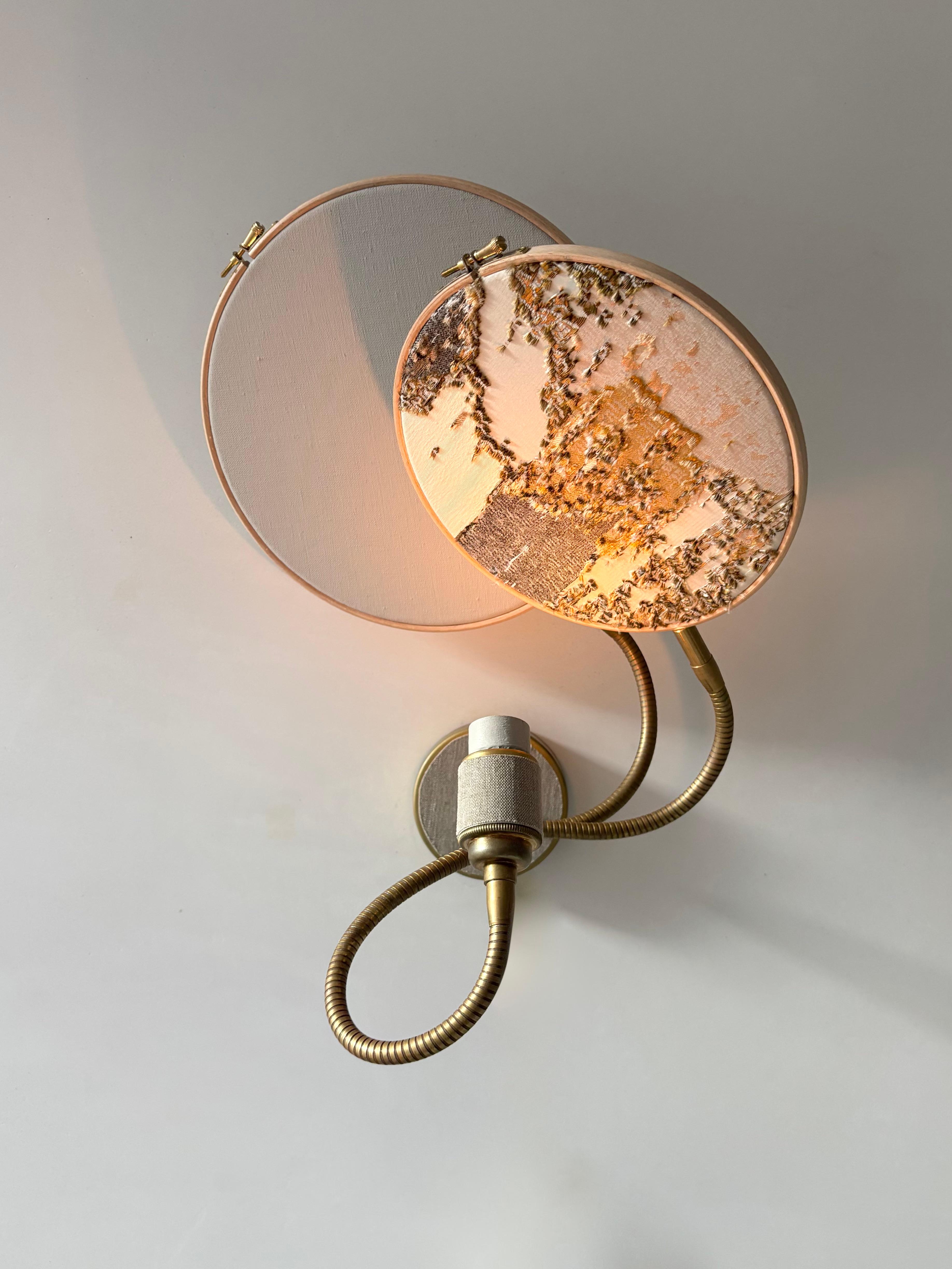 No. 33 Wall Lamp, 2 Circles, by Sander Bottinga
Dimensions: D 25 cm x W 38 cm x H 40 cm
Materials: brass, wood, grey hand-painted linen, marble embroidered design in silk, viscose, cotton.

Available with 2 circles or 1 circle.
Available in grey or