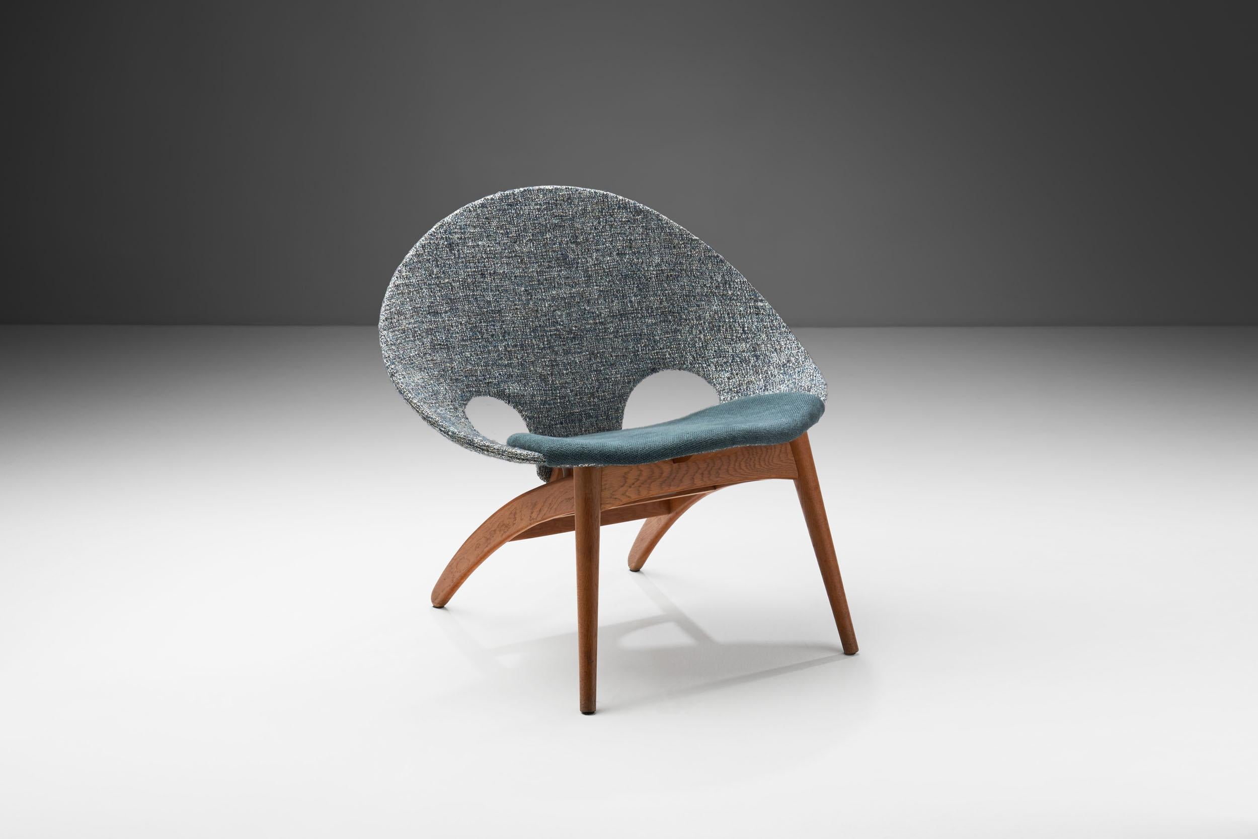 The shape of this “No. 55” shell chair indicates the design of an architect. Indeed, Arne Hovmand-Olsen was a prolific Danish designer and architect, whose designs centered around the traditional values of Scandinavian design: simple and clear