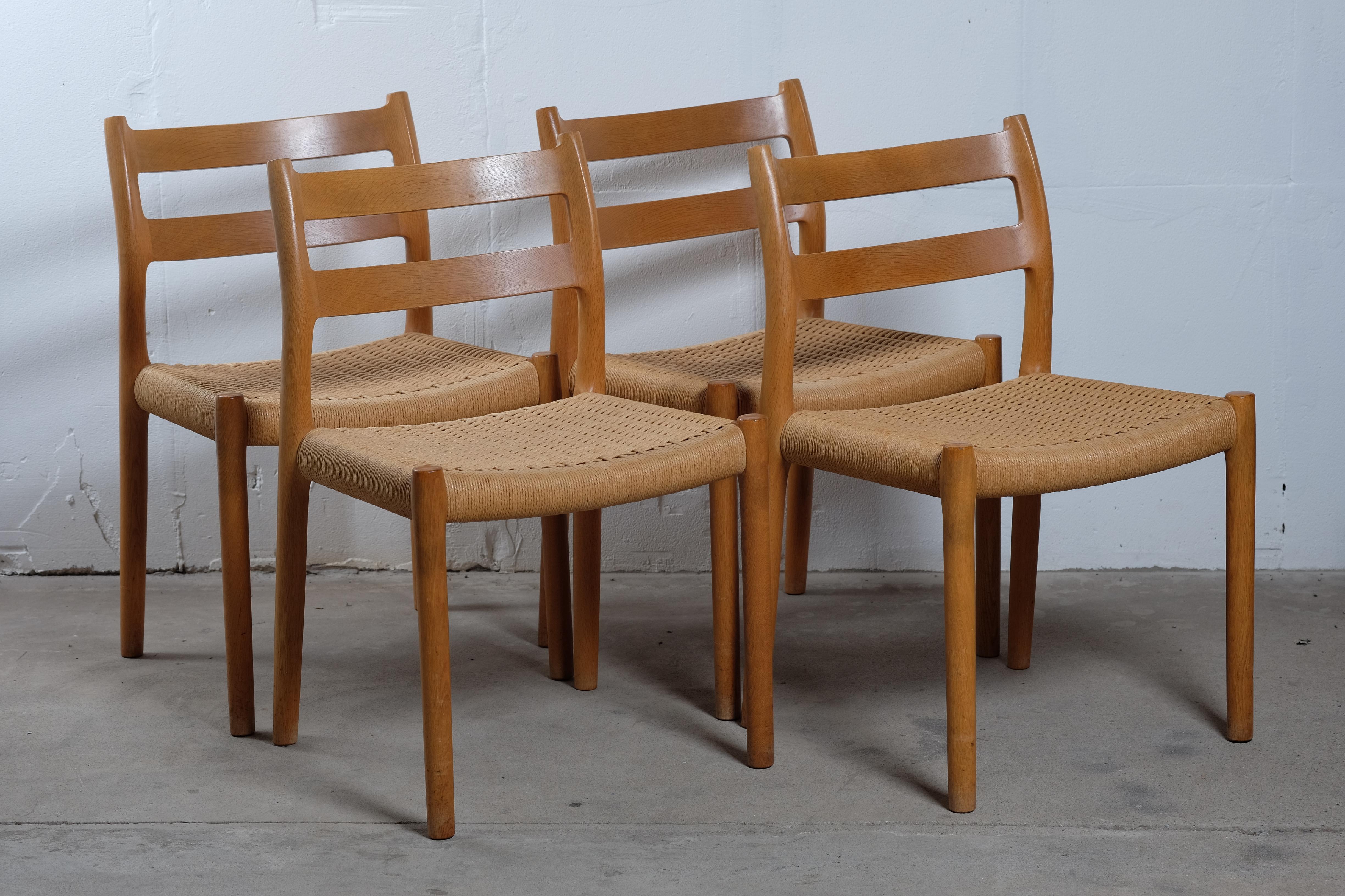 Set of four N.O. Møller  for J.L. Møller Dining chairs in Oak Model No.84 with paper cord seats. Great chair with a lot of comfort and outstanding quality that goes hand in hand with the beautiful design. The chairs and the paper cord seats are in