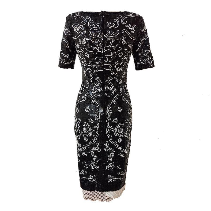 Beautiful dress totally adorned with sequins and jaisse Black and white Short sleeve Shoulder/hem cm 108 (32,28 inches) Shoulders cm 40 (15,74 inches)