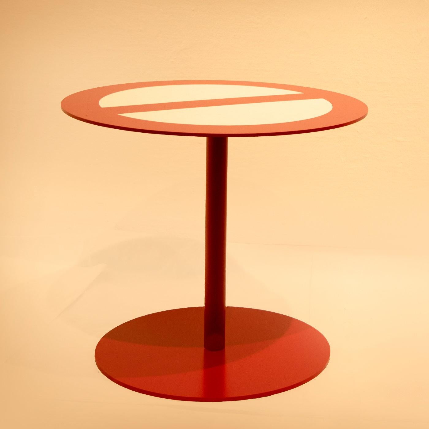 Entirely crafted by hand, this iron coffee table is a decor piece that will infuse a unique character to an eclectic home or office decor. Featuring a red-finished pedestal leg and circular base, the top reproduces a 