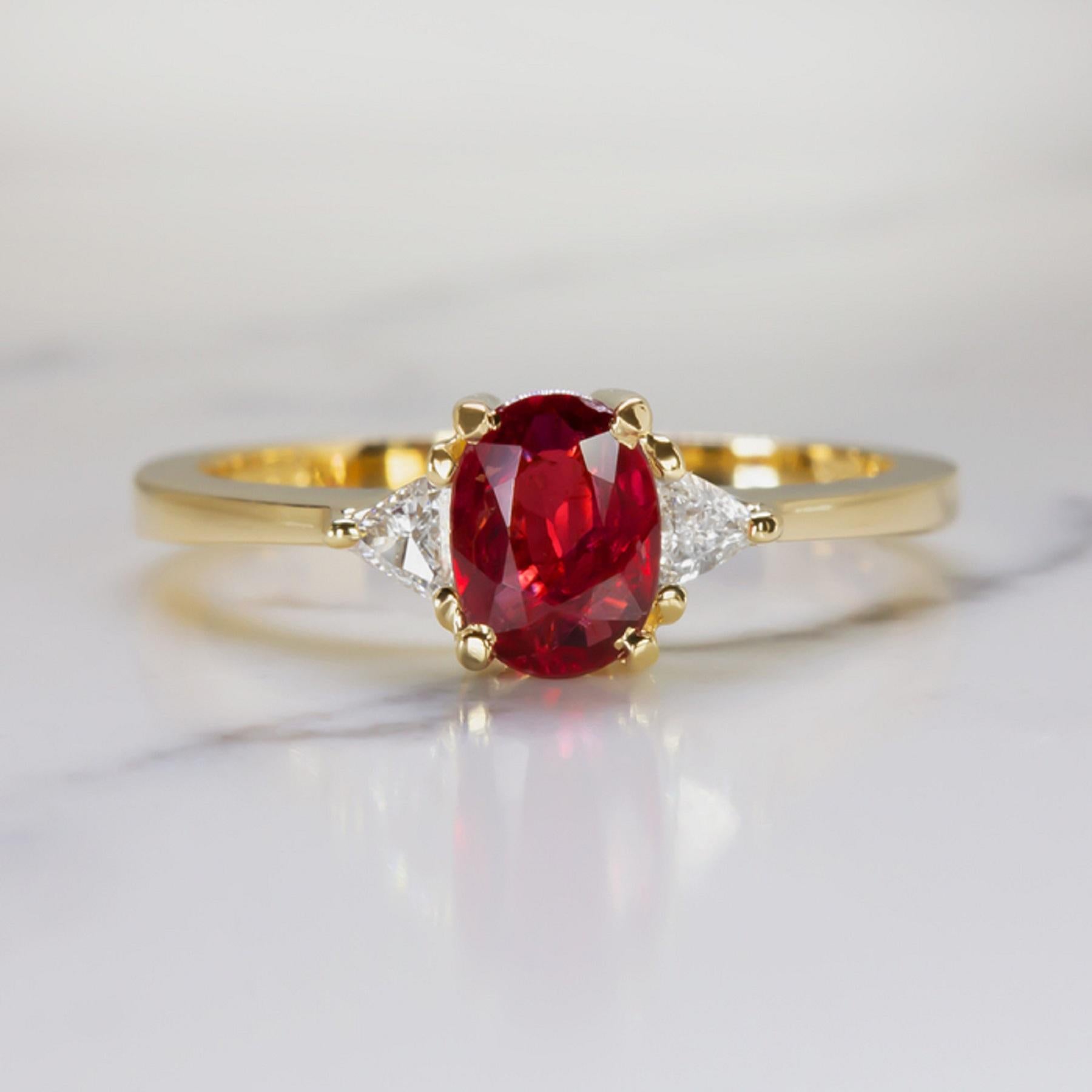 An exquisite rich color and bright sparkle, this elegant ring pairs a 0.82 carat unheated ruby with a pair of vibrant trillion cut diamonds. The 0.82 carat ruby is certified as unheated, and it is an absolutely stunning, even, and richly saturated