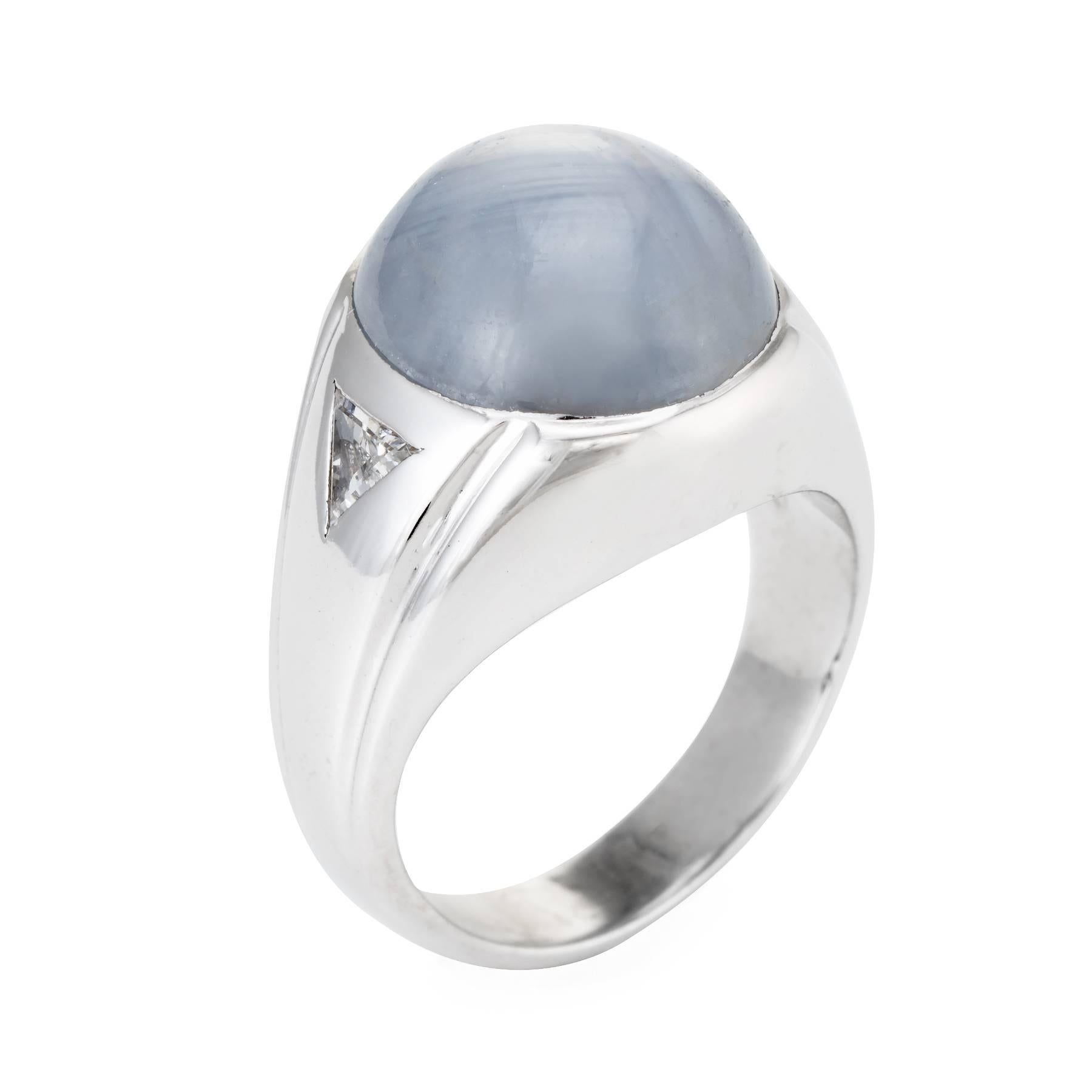 Finely detailed men's ring, crafted in 14 karat white gold. 

Oval cabochon cut natural star sapphire, approx. 17.60 carats (14.4 x 12.6 x 9.0mm), light gray color, moderately included, good cut, moderate star, Sri Lanka origin, not heated. The