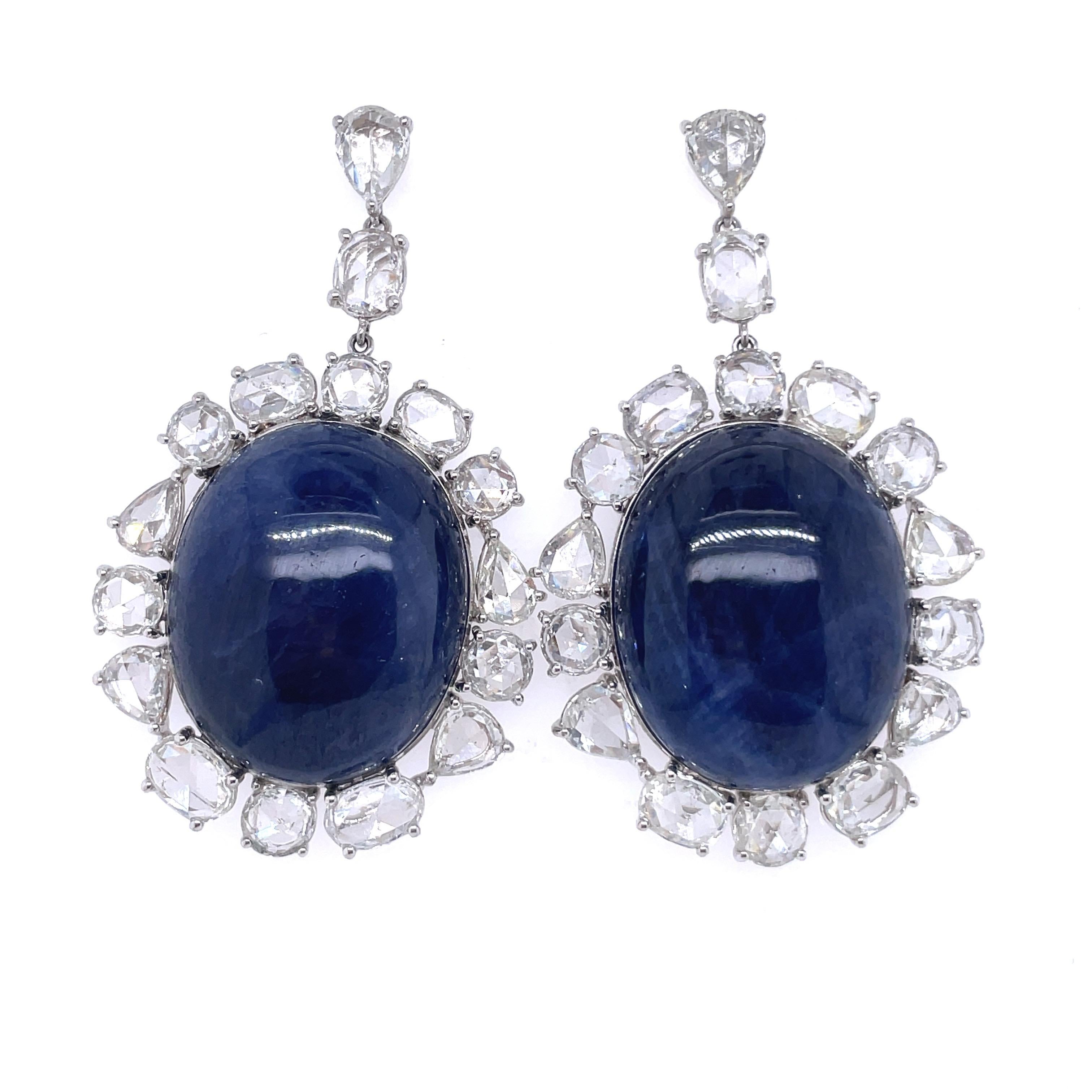 No Heat Burma Blue Cabochon Sapphire Earrings in 18 K  White Gold, Antique Cut  Diamonds and Swiss GRS Certificate

Beautiful set of Natural, no heat, Burma Oval Cabochon Blue Sapphire (146.70 cts) earrings of ideal color with a surround of Antique