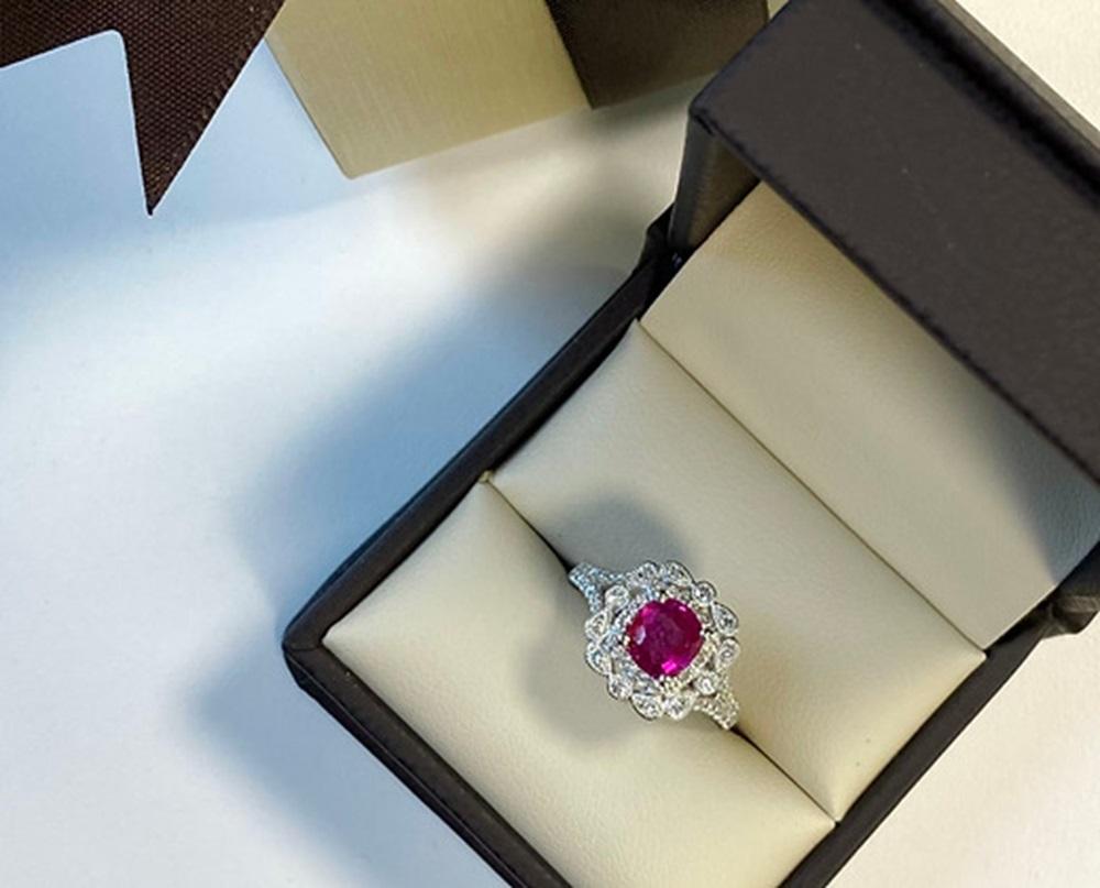 Ruby Weight: 1.29 Cts, Diamond Weight: 0.46 Cts, Metal: 18K White Gold, Ring Size: 6.5, Shape: Cushion, Color: Pinkish-Red, Origin: Burma, Treatment: No gemological evidence of heat, Hardness: 9, Birthstone: July