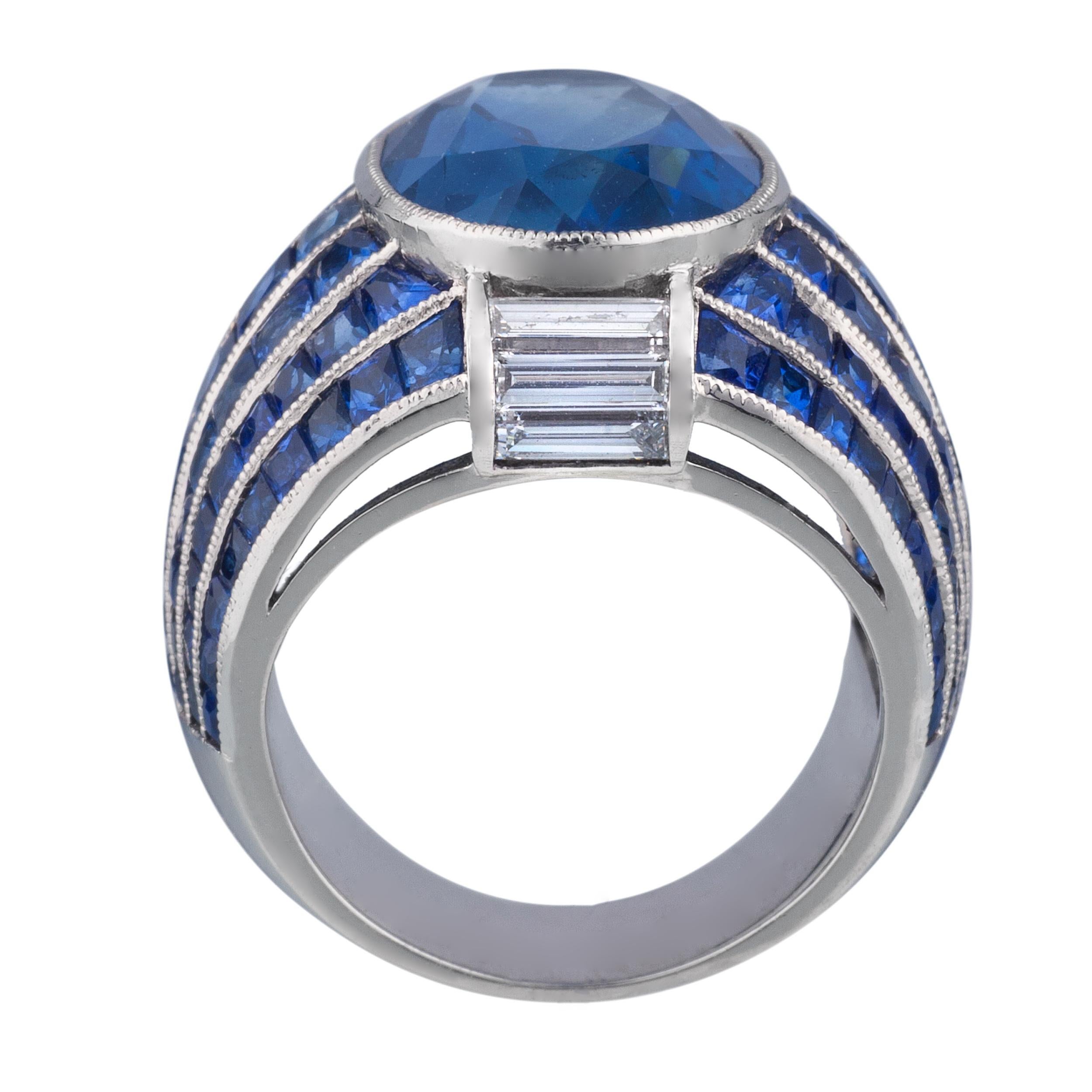 Platinum Ring with 13.53 carat Burma Sapphire and smaller sapphires weighing 7.48 carats and diamonds weighing 0.69 carats.