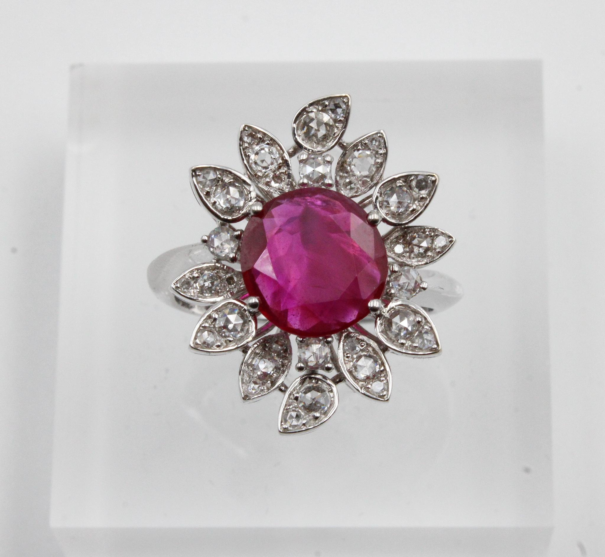 This extraordinary cluster ring features a rare and highly desirable Burmese ruby from the famed Mogok region, certified by GRS as natural, untreated (no heat). The ruby’s rich, vivid red color is beautifully showcased at the center of a