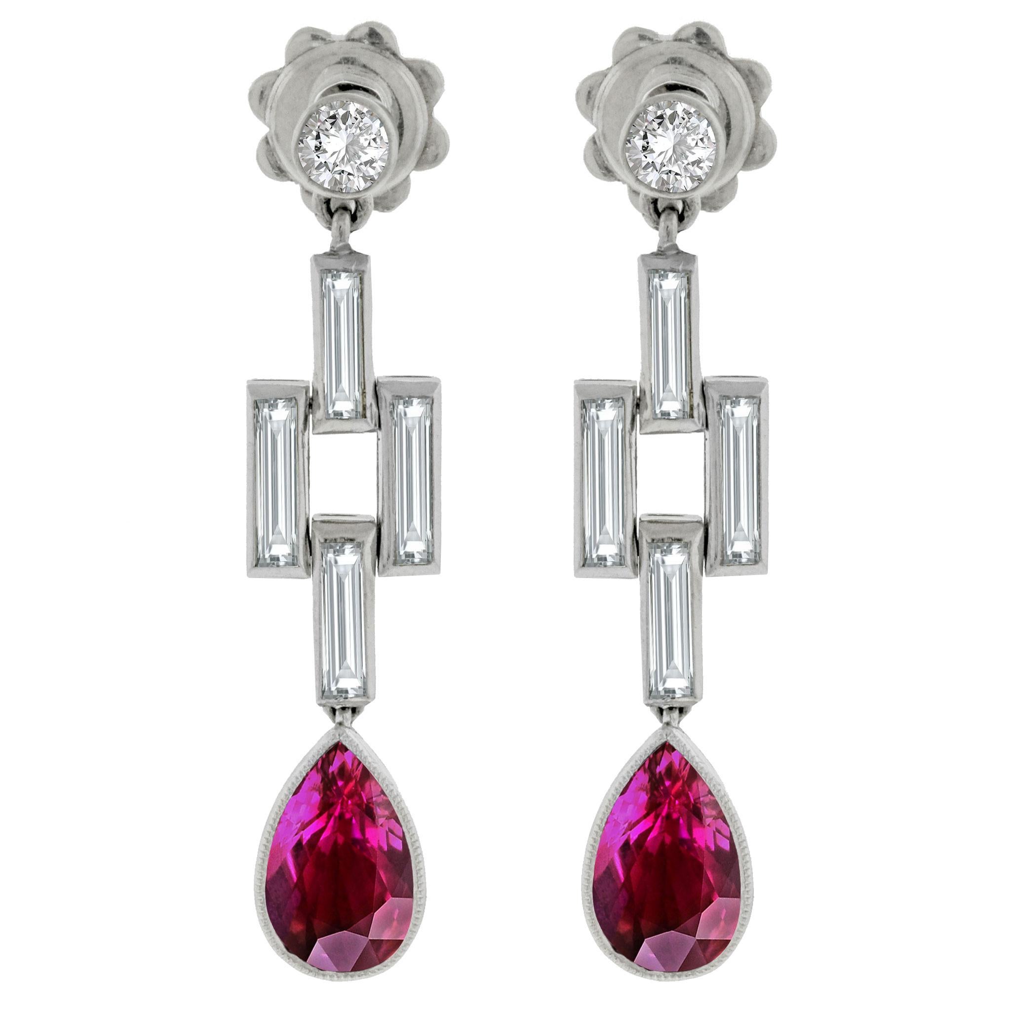 A sublime pair of vintage earrings featuring 2 rare unheated Burmese rubies. They are shaped as beautiful pears and have a bright vivid color found only in the finest of rubies. They are complemented by 1.50 carats of baguette and round
