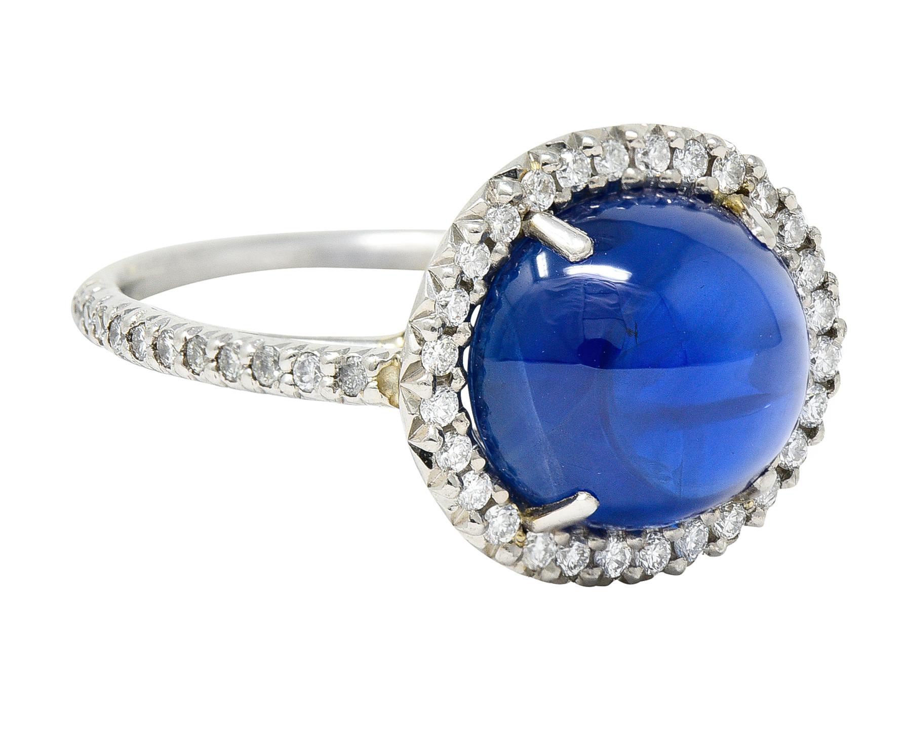 Featuring an oval Ceylon sapphire cabochon weighing approximately 7.19 carats

Royal blue and translucent with natural inclusions with no indications of heat - Sri Lankan origin

Surrounded by a round brilliant cut diamond halo and