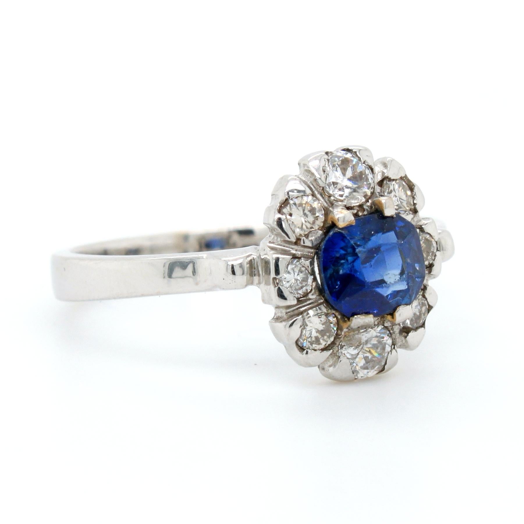 A sapphire and diamond ring in white gold. The cushion sapphire weighs 0.84 carats, is natural, not heated, and of Kashmir origin - accompanied by an IGI certificate. It has strong blue colour and no eye visible inclusions, with some colour zoning