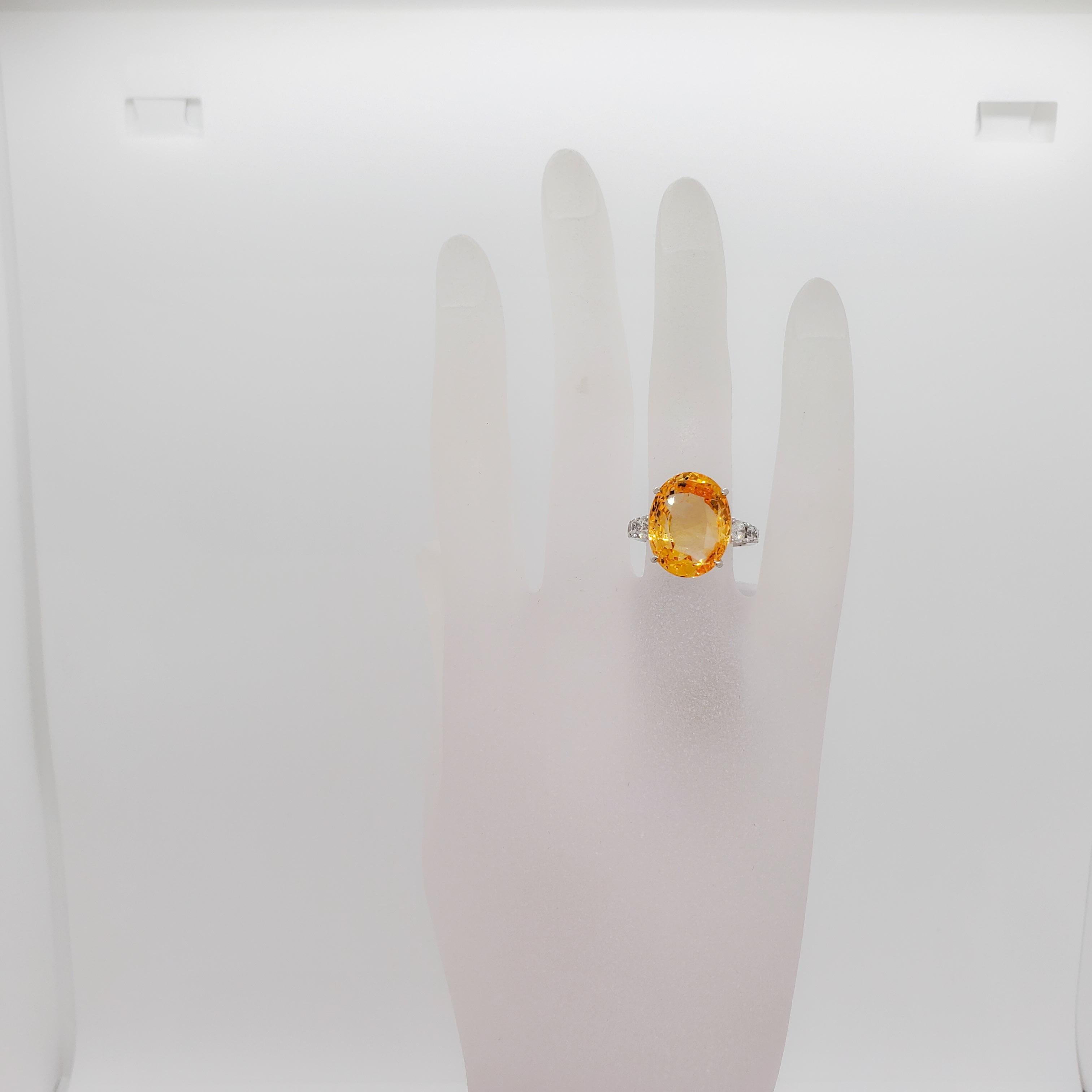 Gorgeous golden 14.46 ct. Sri Lanka yellow sapphire oval with 0.67 ct. good quality white diamond rounds.  Handmade platinum mounting in ring size 6.  Yellow sapphire is no heat.  