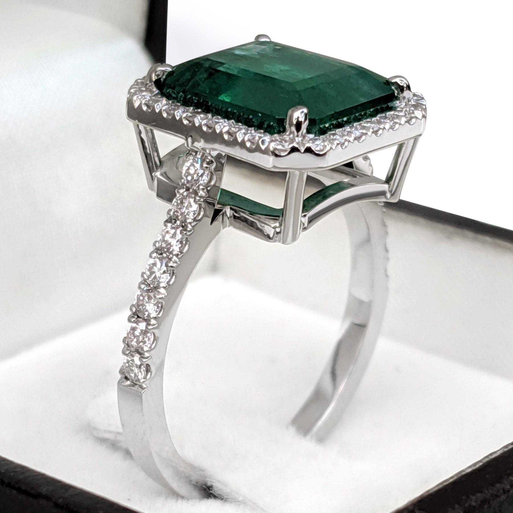 Ring can be resized free of charge prior to shipping out.
Ring Size: 56 EU

Center Natural Emerald:
Weight: 4.83 ct
Color: Green
Shape: Cut Cornered Rectangle Step Cut
No indications of treatment

Side Stone Diamonds:
Weight: 0.55 ct / 44