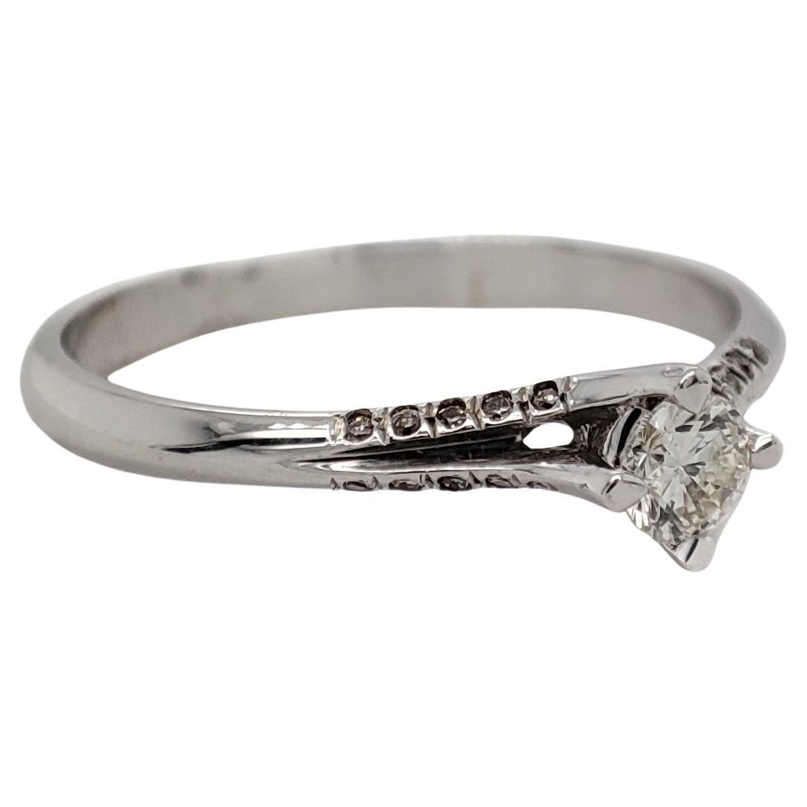 FOR US CUSTOMER NO VAT!

This elegant ring features a central 0.20-carat light yellow diamond with a clarity of SI2, adding a touch of warmth and subtle color to the design.

Crafted in 14K white gold, the ring is designed for a size 6.5 and has a