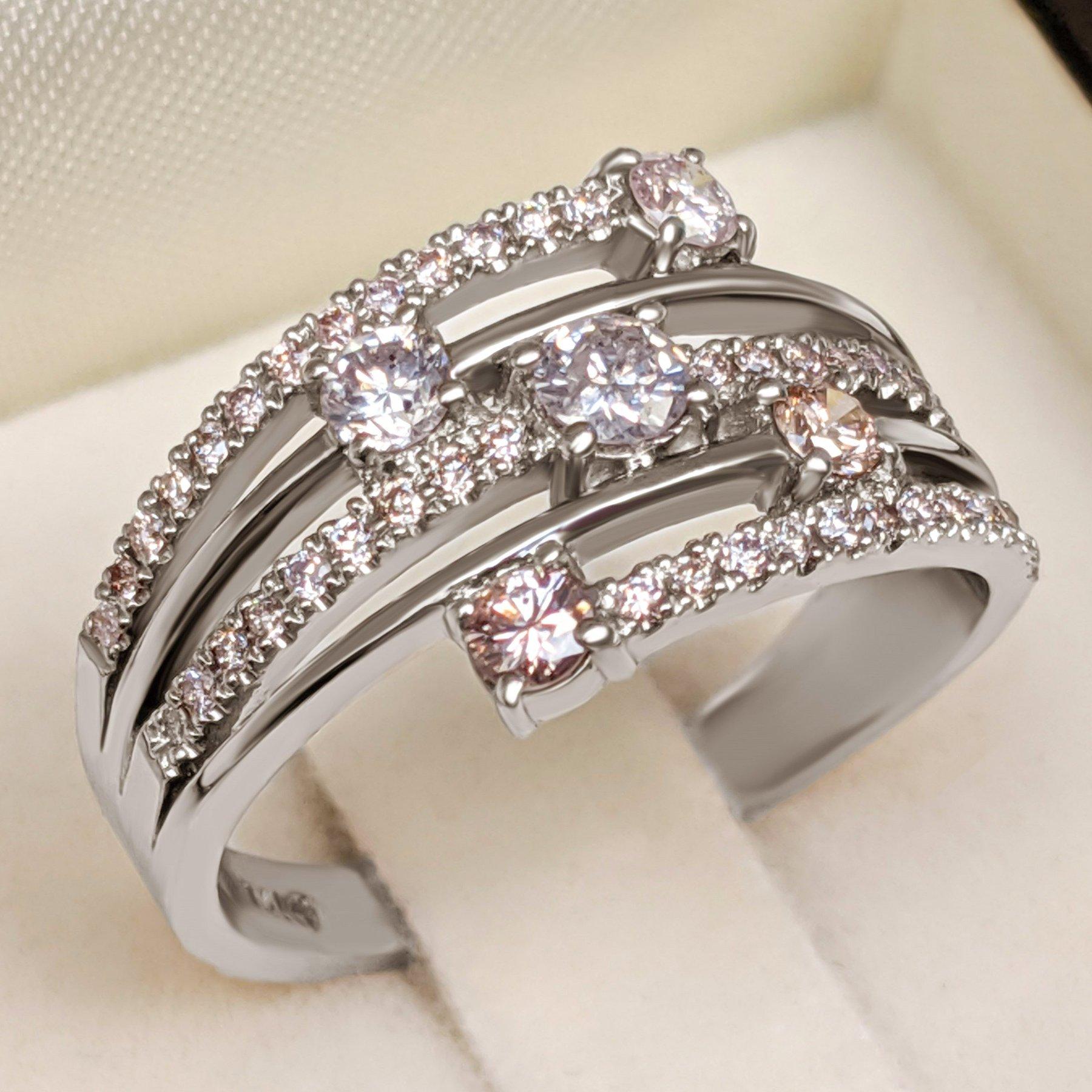 This stunning ring showcases a total of 0.80 carats of natural pink diamonds, set in elegant 14 kt white gold. The delicate pink hue of the diamonds adds a touch of romance and sophistication, making this ring a timeless and enchanting piece.