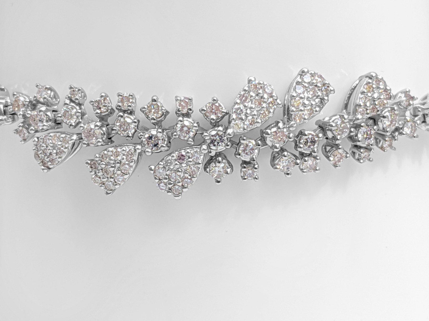 Side Stones:
___________
Natural Diamonds
Cut: Round Brilliant
Carat: 1.51 cttw / 93 stones
Color: Fancy Light Pink
Clarity: VS-SI

Size: 18 cm

Item ships from Israeli Diamonds Exchange, customers are responsible for any local customs or VAT fees