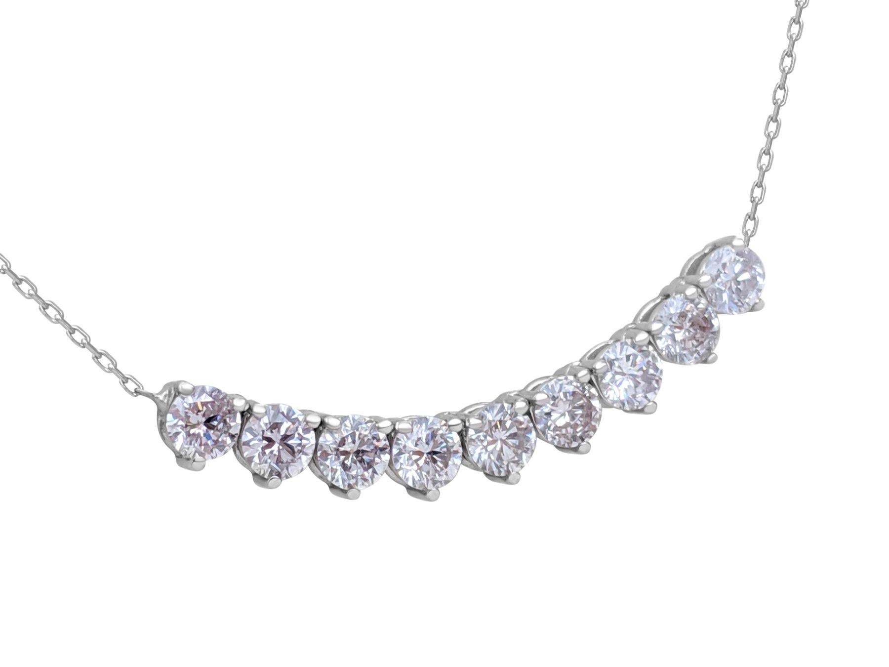 This enchanting necklace features a pendant adorned with 1.56 carats of natural colored pink diamonds, set in 14 kt white gold. The delicate pink diamonds are beautifully complemented by the warm and romantic hue of the white gold setting. Certified