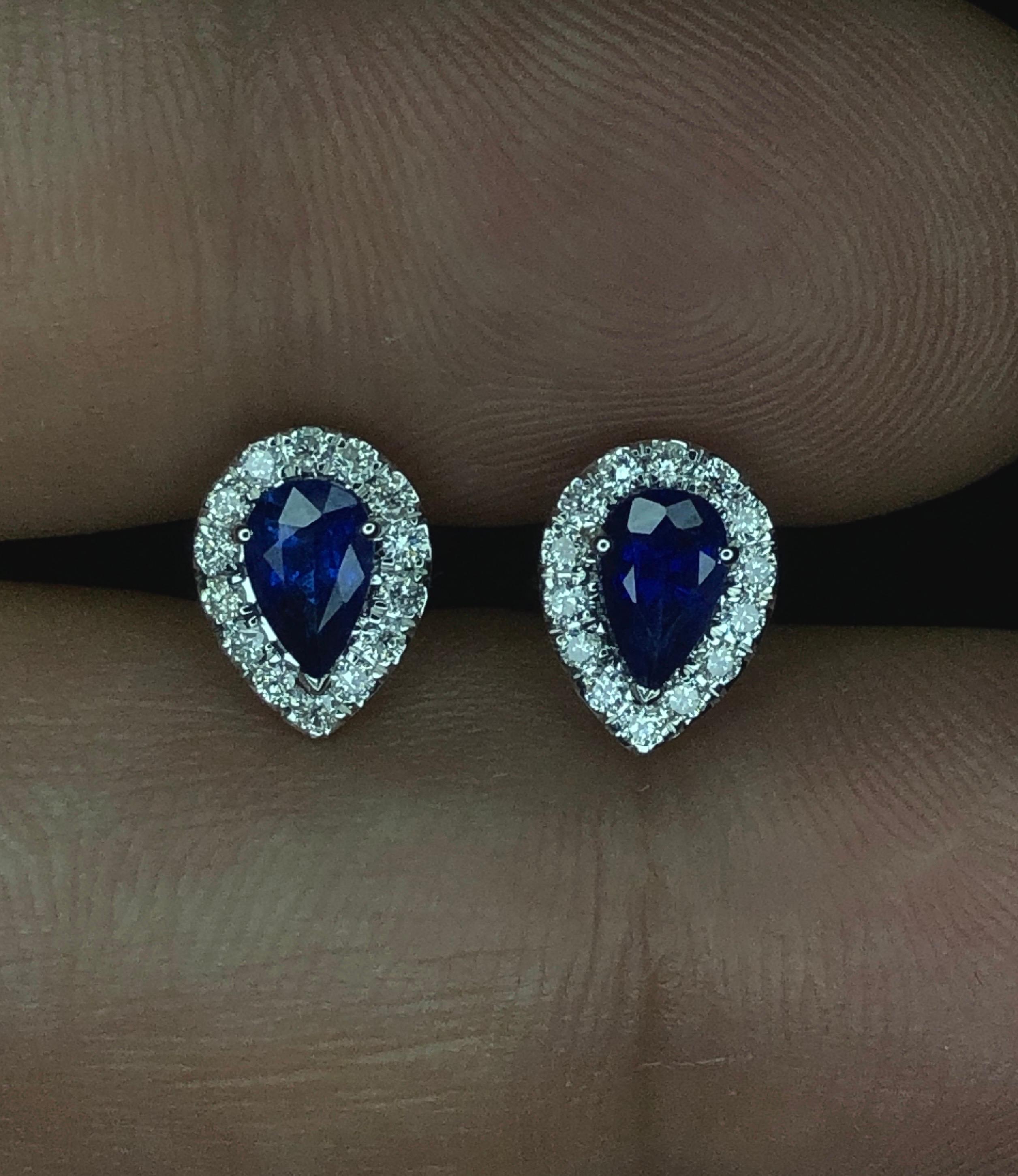 Introducing our exquisite Pear Shape Ceylon Sapphire Earrings, crafted in 18k gold and adorned with stunning diamonds. Each earring boasts a lustrous pear-shaped Ceylon sapphires, In royal Blue.surrounded by a halo of brilliant diamonds. Elevate