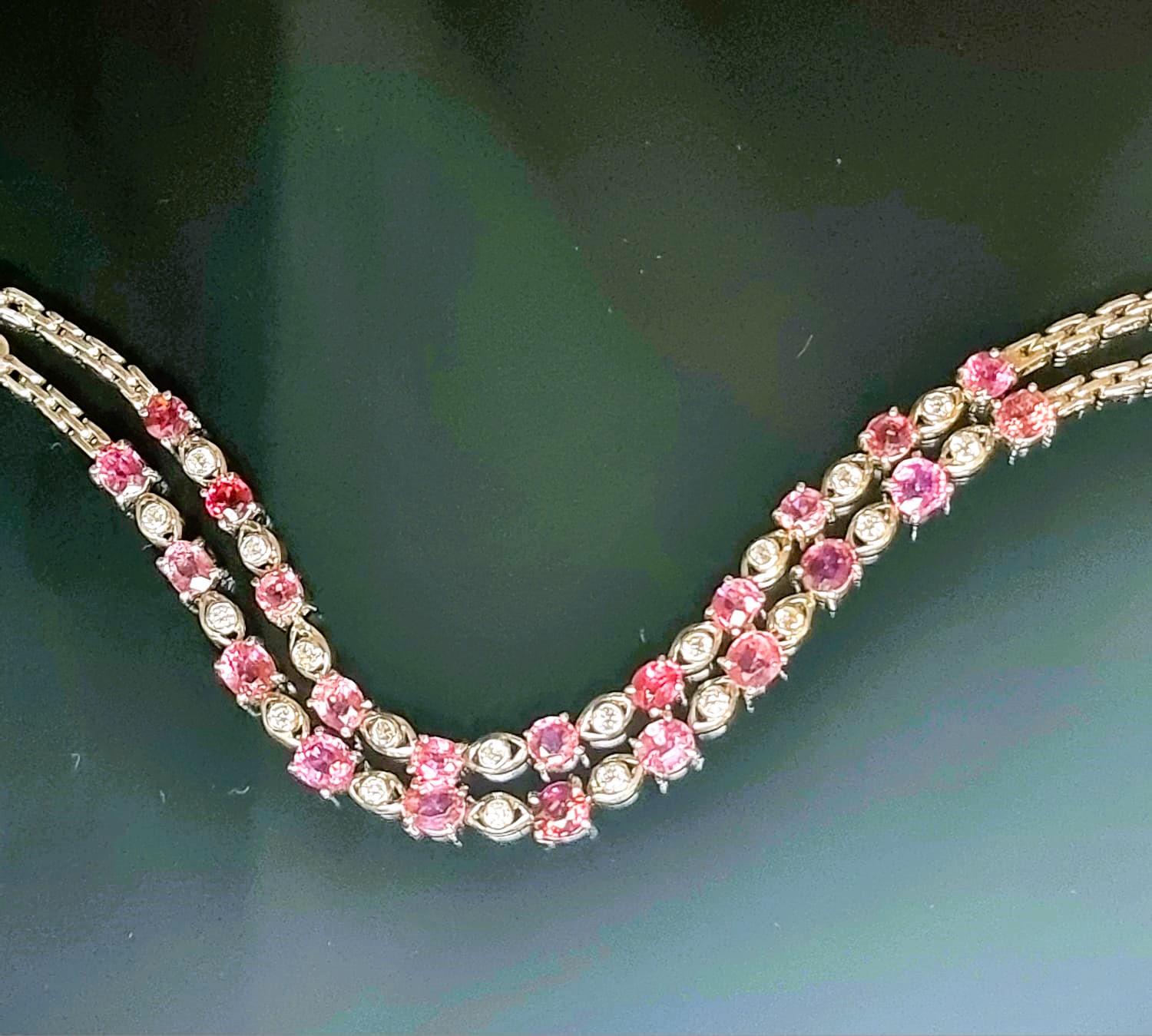 Indulge in the captivating charm of our 10 Stone Pink Tourmaline and Zircon Tennis Bracelet, where each pink tourmaline gemstone weighs an impressive 0.75ct featuring a total of 7.5ct of richly hued pink tourmalines, each one prong-set to