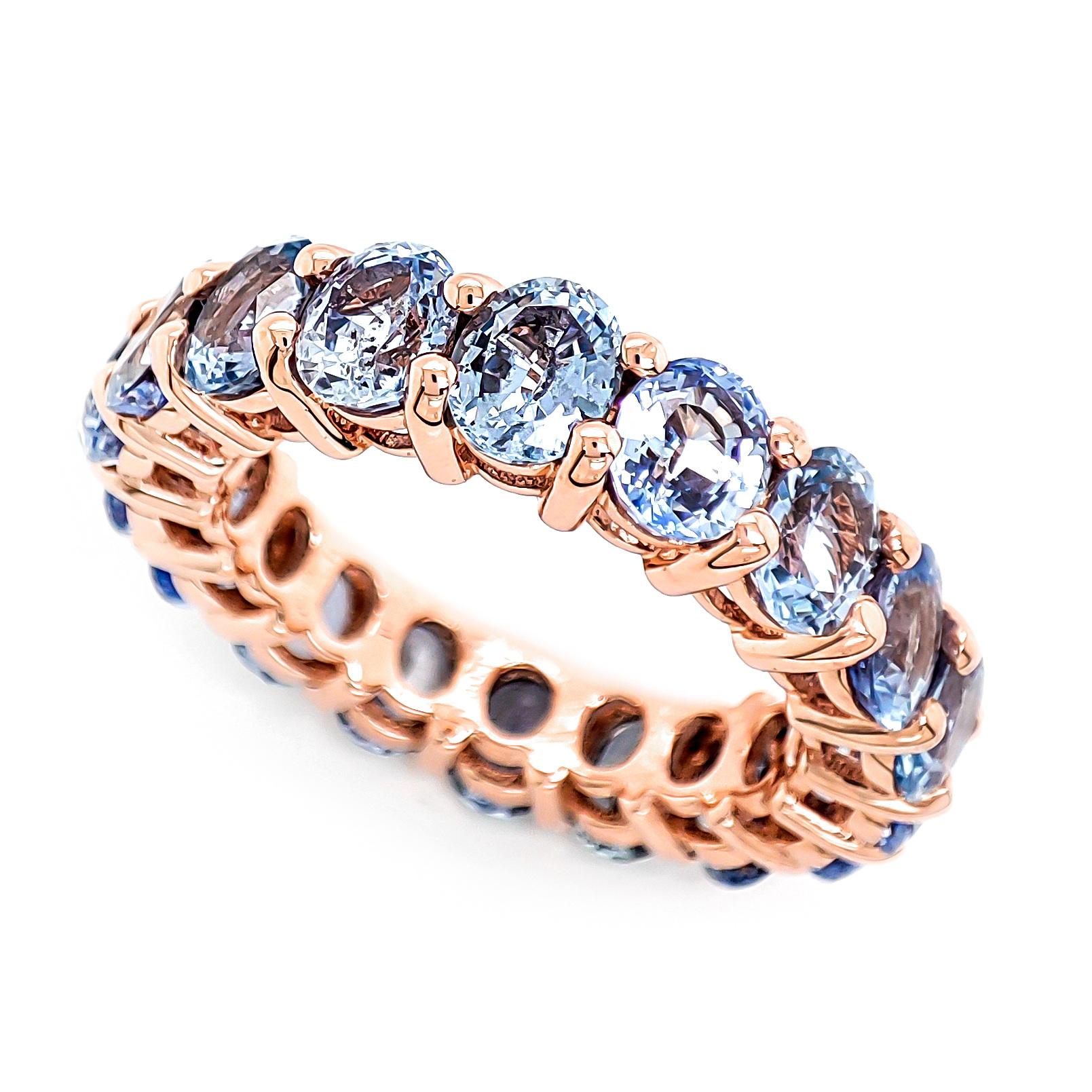 FOR US BUYERS NO VAT

Embrace a world of enchantment with this 14K rose gold eternity ring featuring a dazzling array of 18 sapphires totaling 8.00 carats. The blue sapphires, create a captivating spectrum of color, evoking a sense of tranquility