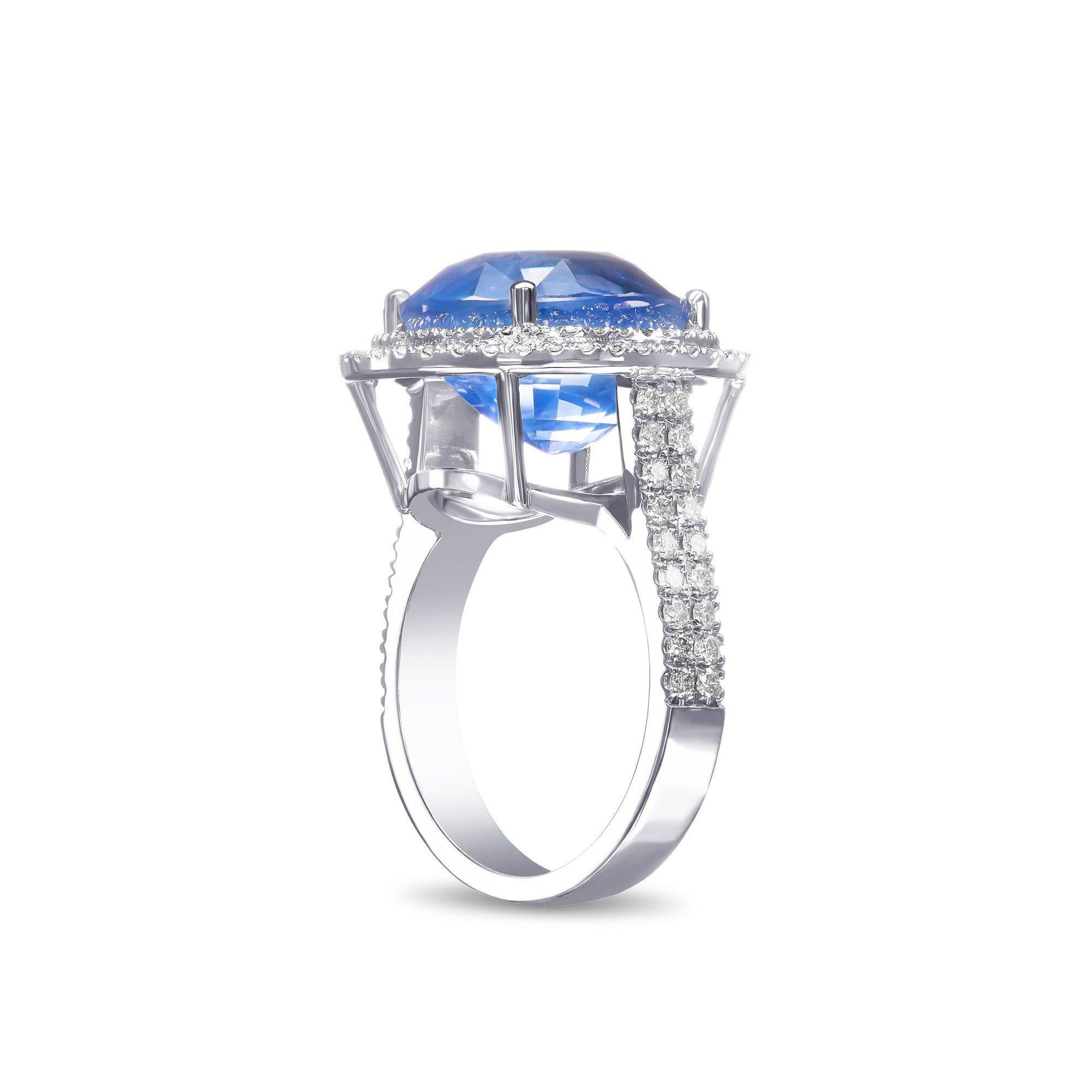 Ring can be sized free of charge prior to shipping out.    

Center Natural Sapphire:
Weight: 14.35 carat
Color: Violetish Blue 
Shape: Oval Mixed
No Indications of heating

Side Stone:
___________
Natural Diamonds
Cut: Round Brilliant
Carat: 1.30