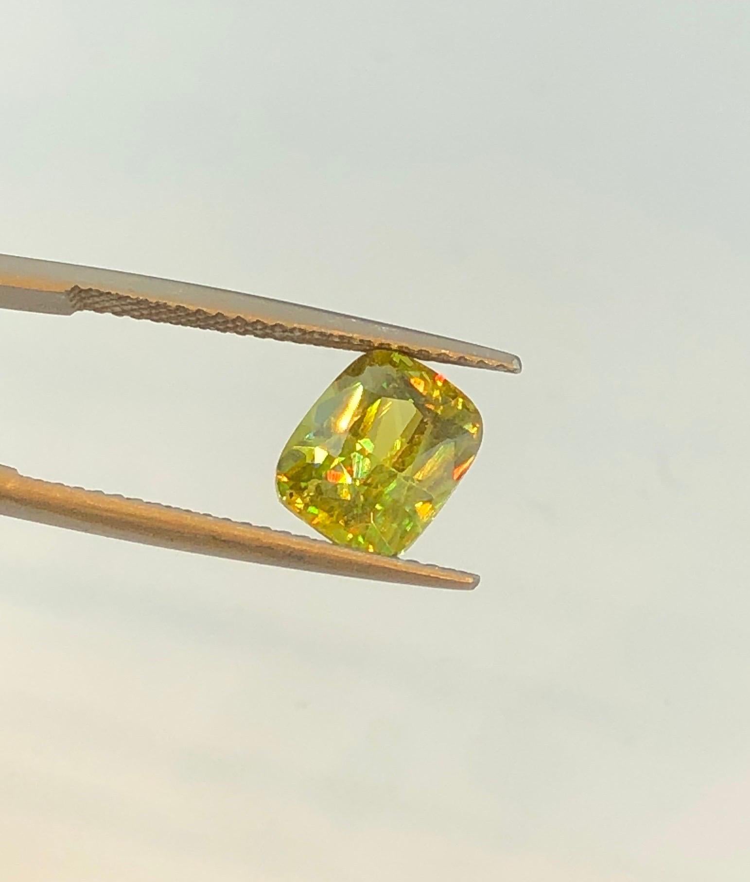 We are thrilled to present a beautiful 2.5-carat yellowish-green sphene, perfect for a dazzling ring. Known for its exceptional fire, this gemstone truly comes alive in artificial lighting, displaying more light dispersion than a diamond. Experience