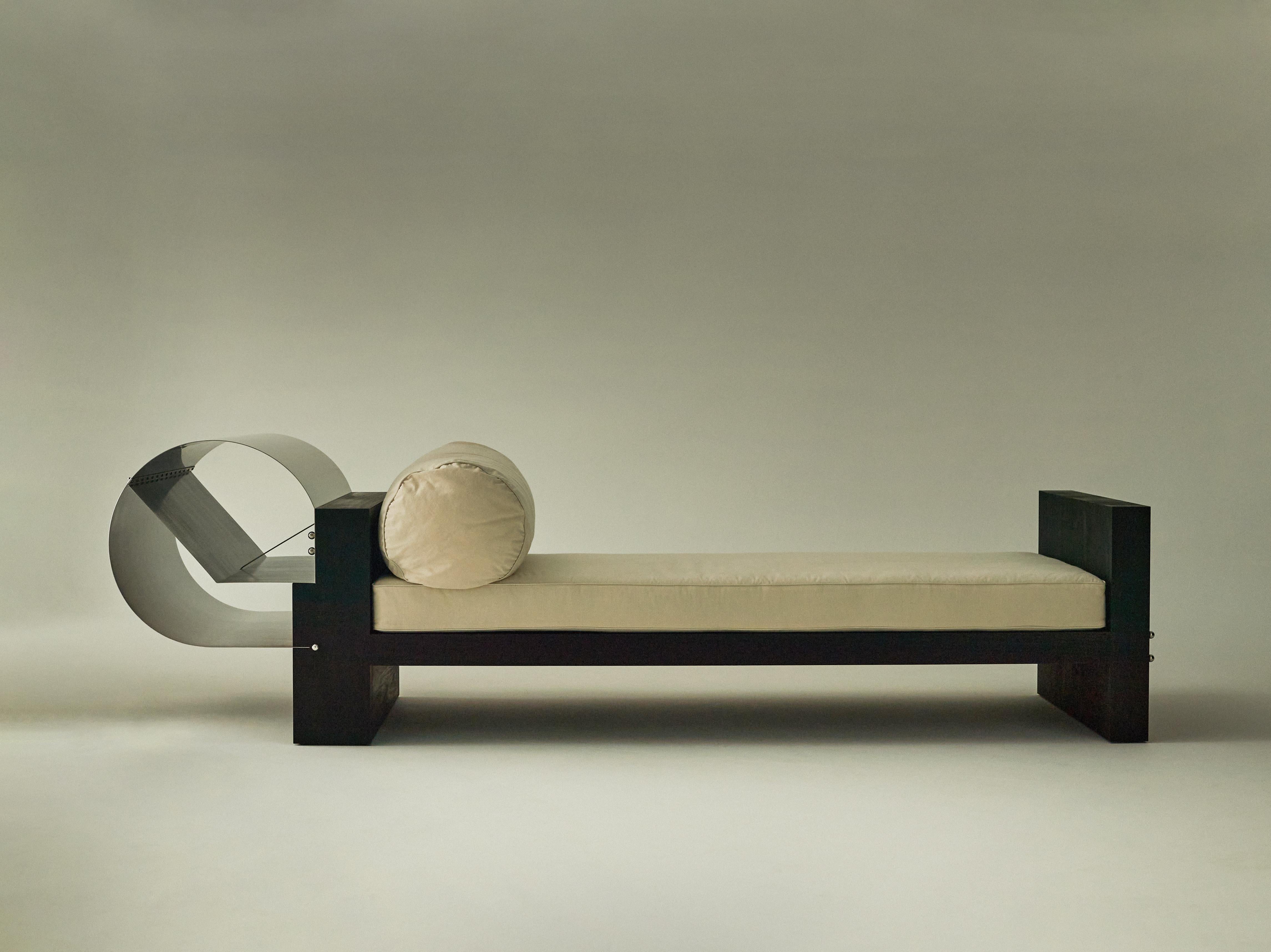 No.0422 daybed by Olivia Bossy
Limited Edition of 3
Dimensions: D 267 x W 90 x H 78 cm
Materials: Ebonised Tasmanian Blackwood, stainless steel, cotton

A collection born of fire, Euclidean geometry and the display mechanism of museum