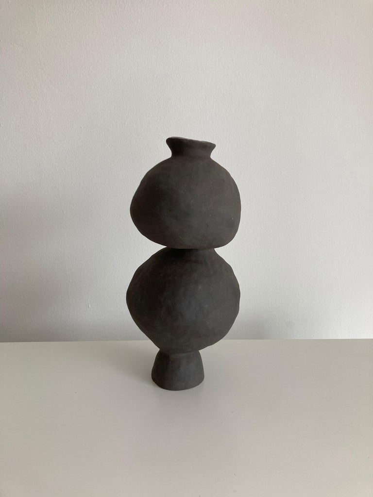 No.100 stoneware sculpture, tonfisk by Ciona Lee 
One of a Kind
Dimensions: Ø 12 x H 10 cm
Materials: black stoneware, unglazed exterior
Variations of size and color available

Tonfisk is the ceramic practice by Ciona Lee, a Korean-Italian