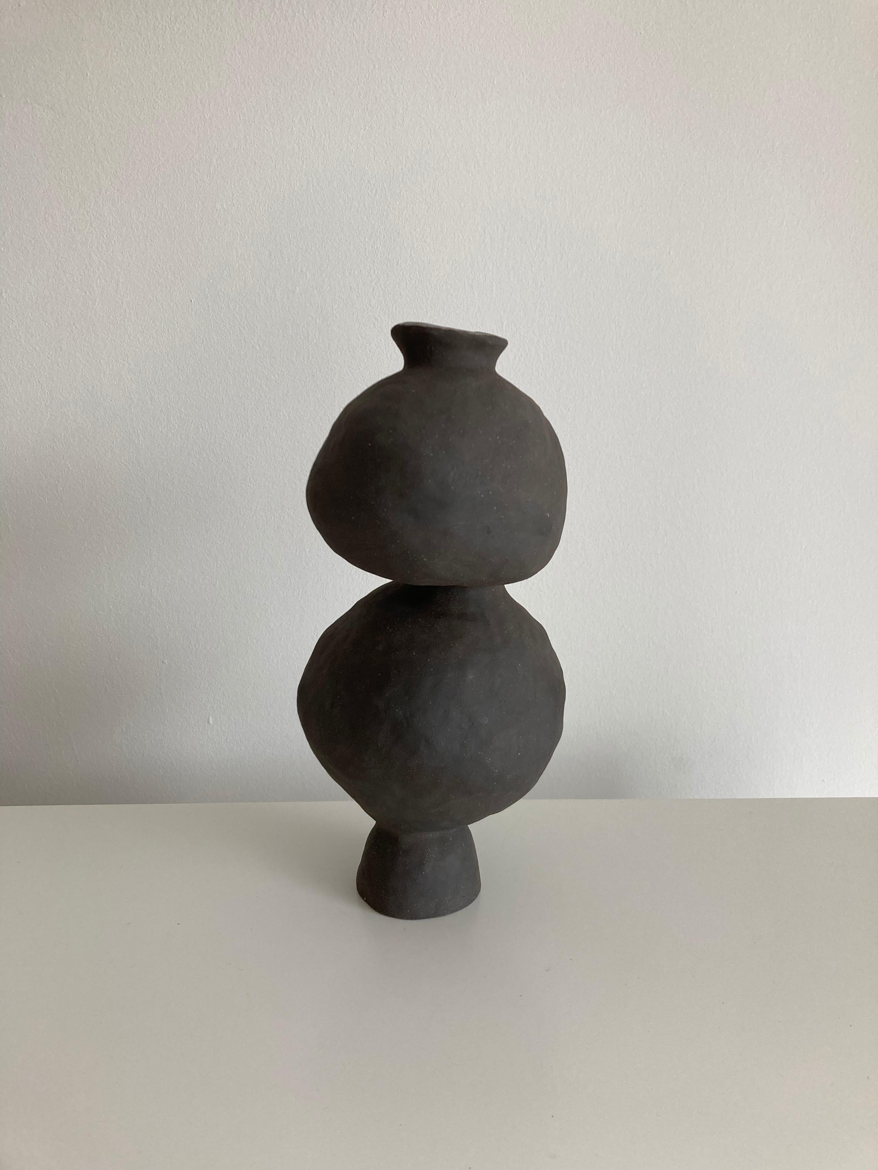 No.100 stoneware sculpture, tonfisk by Ciona Lee.
One of a Kind.
Dimensions: Ø 12 x H 10 cm.
Materials: black stoneware, unglazed exterior.
Variations of size and colour available.

Tonfisk is the ceramic practice by Ciona Lee, a