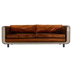 Nº105 Couch by Avoirdupois, a Velvet, Cane and Wood Three Seat Sofa