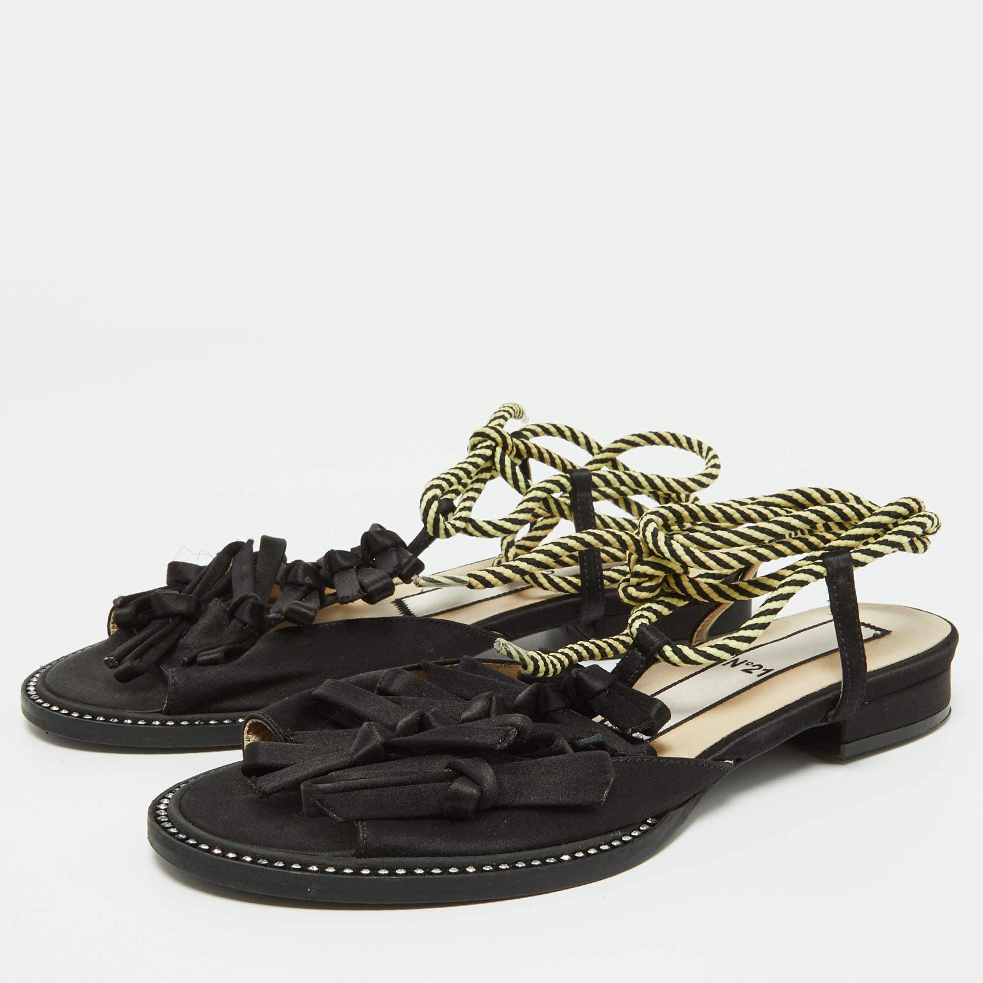 Supremely comfortable and stylish these sandals from the house of NÂº21 feature a royal black satin body. It comes with a knotted front and an open toe silhouette that lend it an interesting shape. Style with culottes or cropped trousers for a