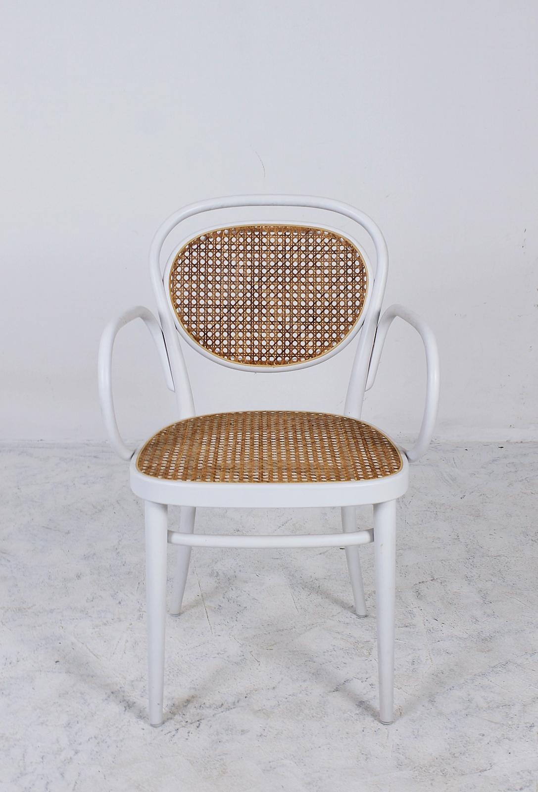 This set of 4 Thonet no. 215 (coffee house) chairs was manufactured 2002 (as marked underneath the seat)
 The chair was designed by Michael Thonet in 1859.
 It features a beech bentwood frame and a rattan seat. Wood and rattan are in good