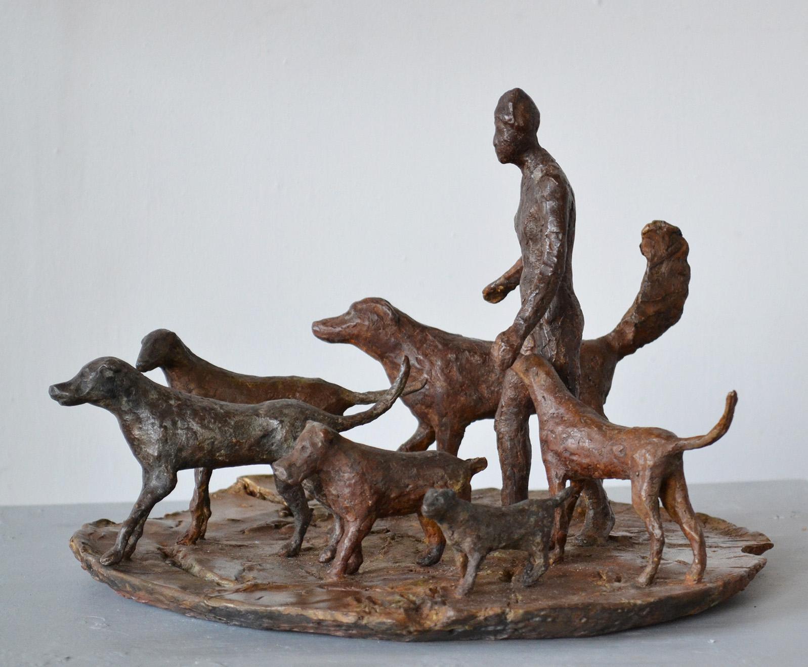 The dogs and their human companion bravely traverse an endangered earth. Cast bronze sculpture, in an edition of 5.
The human figure is 7 ½” x 4” x 2 ½”; the largest dog is 3 ½” h x 6 ½” long x 1 ¼” wide; the smallest dog is: 1 ½” x 2 ¾” x ½”, the