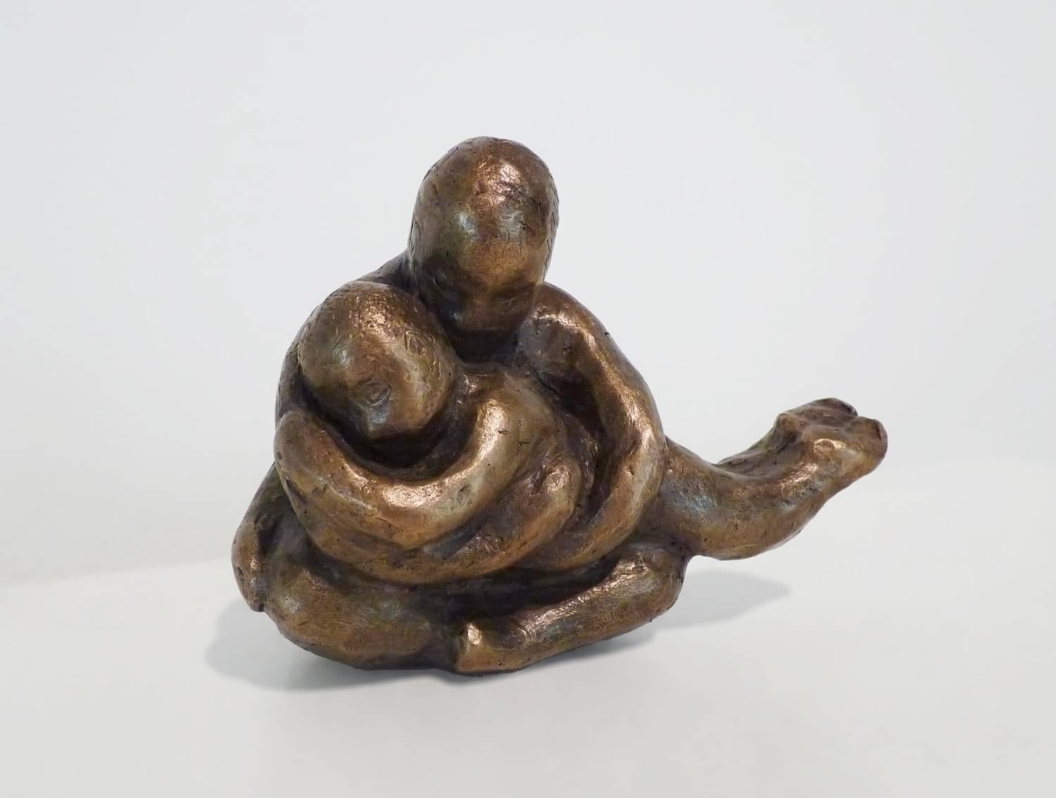 This lovely small bronze in a warm honey brown patina is a depiction of a mother enveloping her child, inspired by a scene sculptor Noa Bornstein witnessed at a train station. 

The optional wooden base (as shown on the second image) is included.