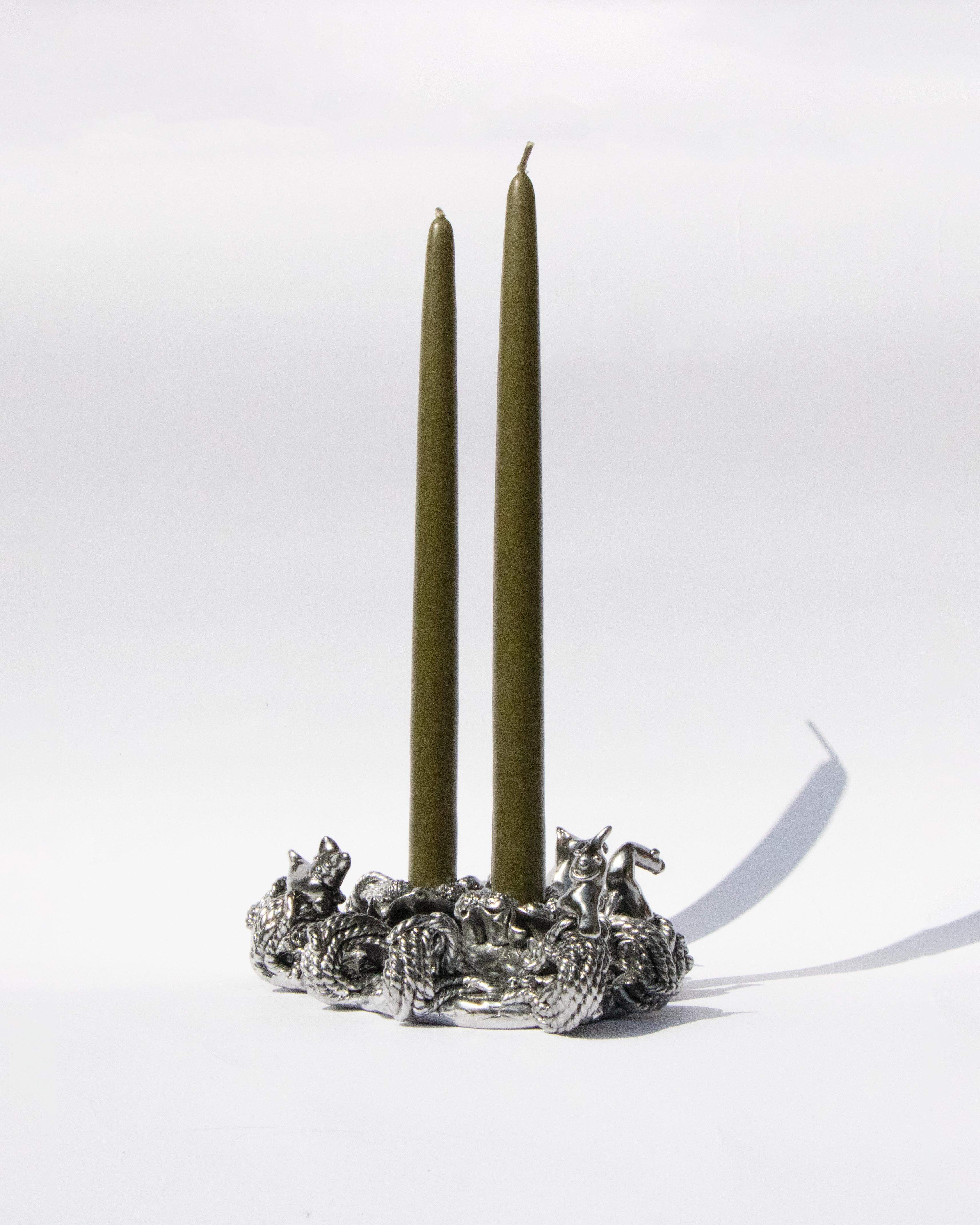 The shapes of this candlestick, take inspiration from the story of Noah's Ark, re-enacted in a not too distant future, where rising sea levels have submerged everything. The protagonists, no longer recognizable animals, but a series of fantastical