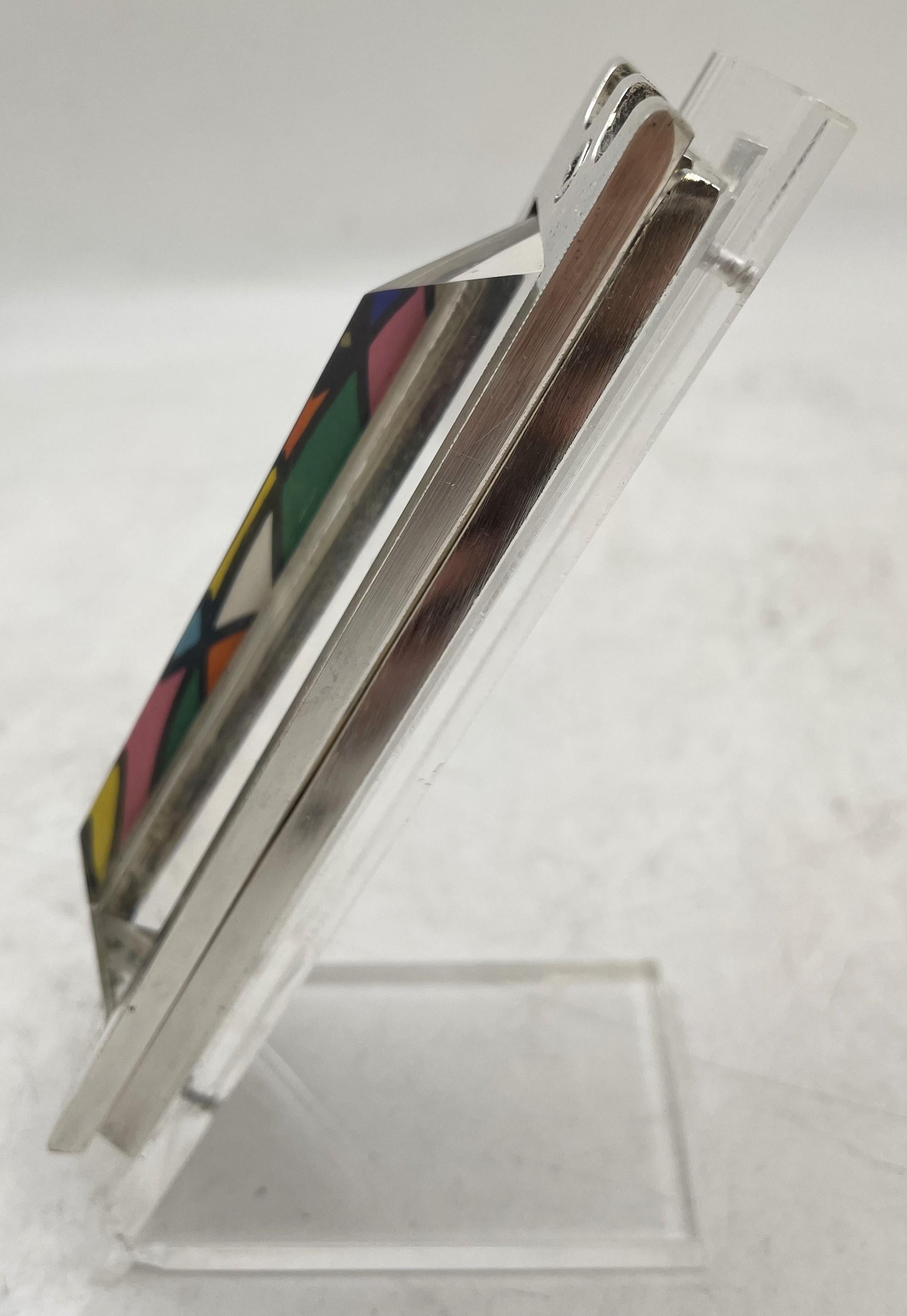 Made by Israel artist Noam Naim Basson, this artistic glass mezuzah with a lucite stand measures 5'' by 1 3/4'' by 2 1/4'' in depth overall (mezuzah measures 4 7/8'' by 1 2/3''). It is signed and numbered 231 out of 250. 

Please feel free to ask us