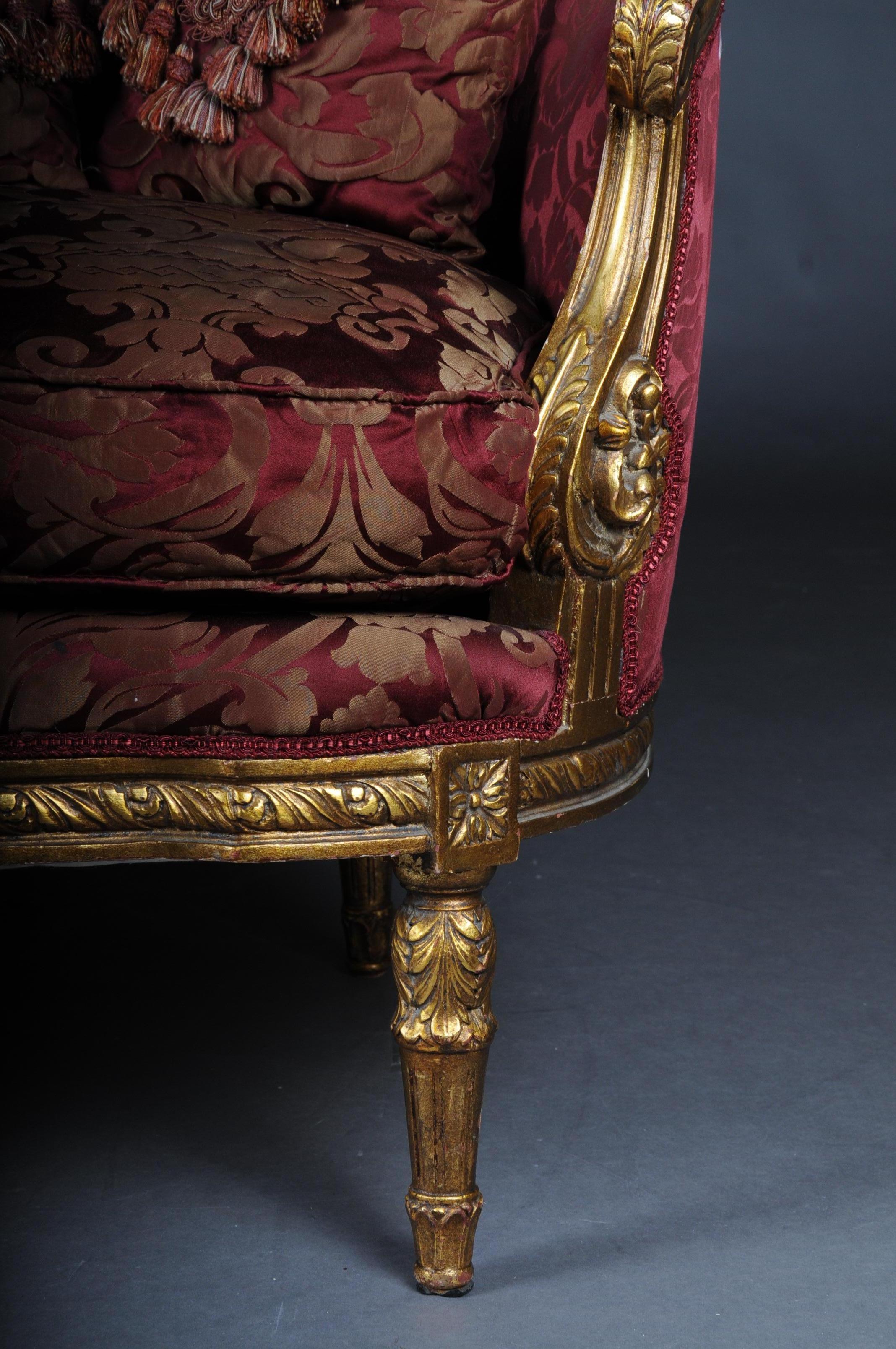 Solid beechwood, carved and gilded. Semicircular rising backrest framing with openwork rocaille crowning. Appropriately curved frame with richly carved foliage. Slightly curved frame on straight legs. Seat and backrest are finished with a