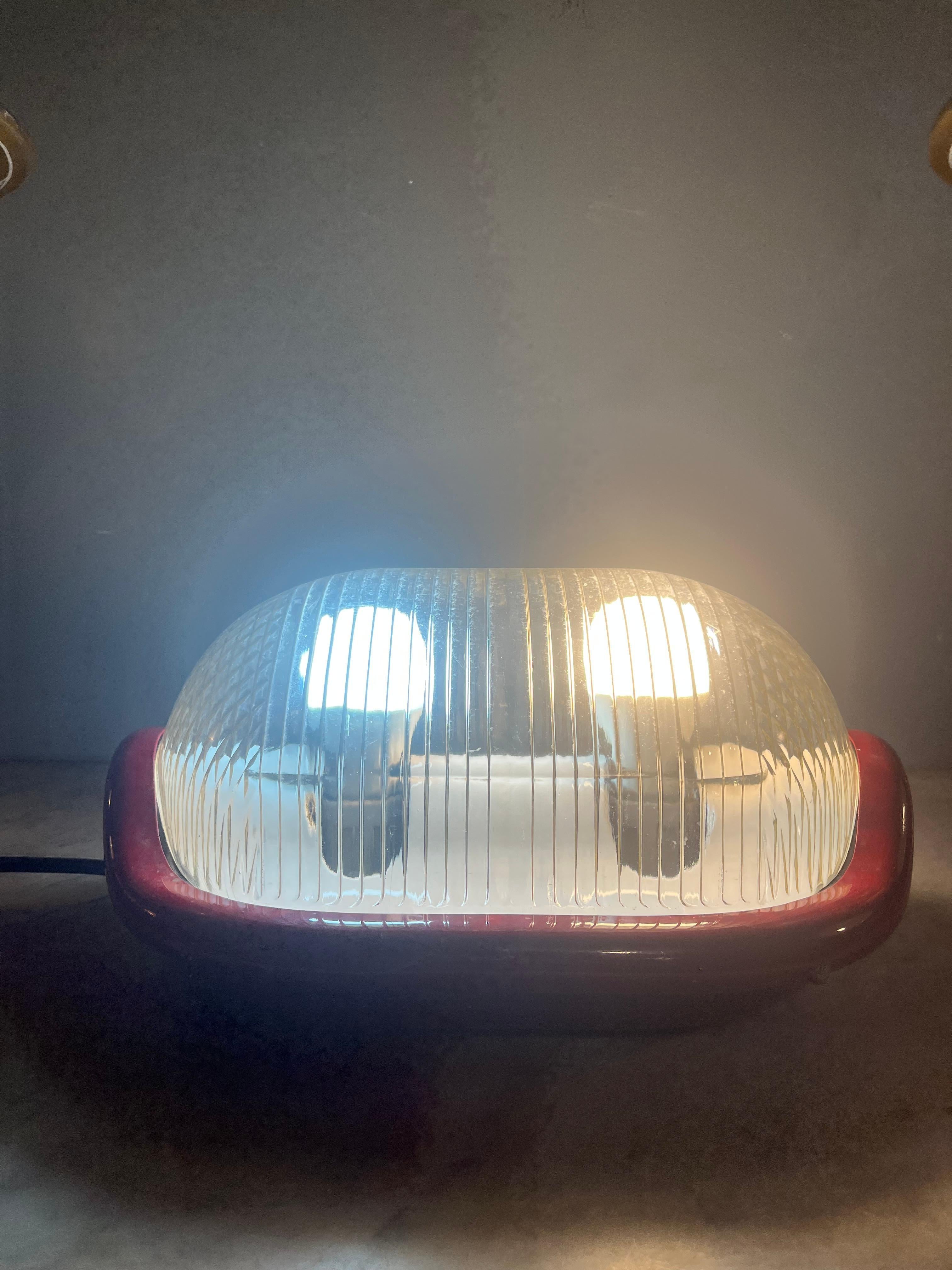 For sale is a rare and fascinating wall lamp designed by Achille Castiglioni for Flos in the 1970s, a piece that perfectly embodies the innovative and playful spirit of one of the undisputed masters of Italian design. This lamp is not only a