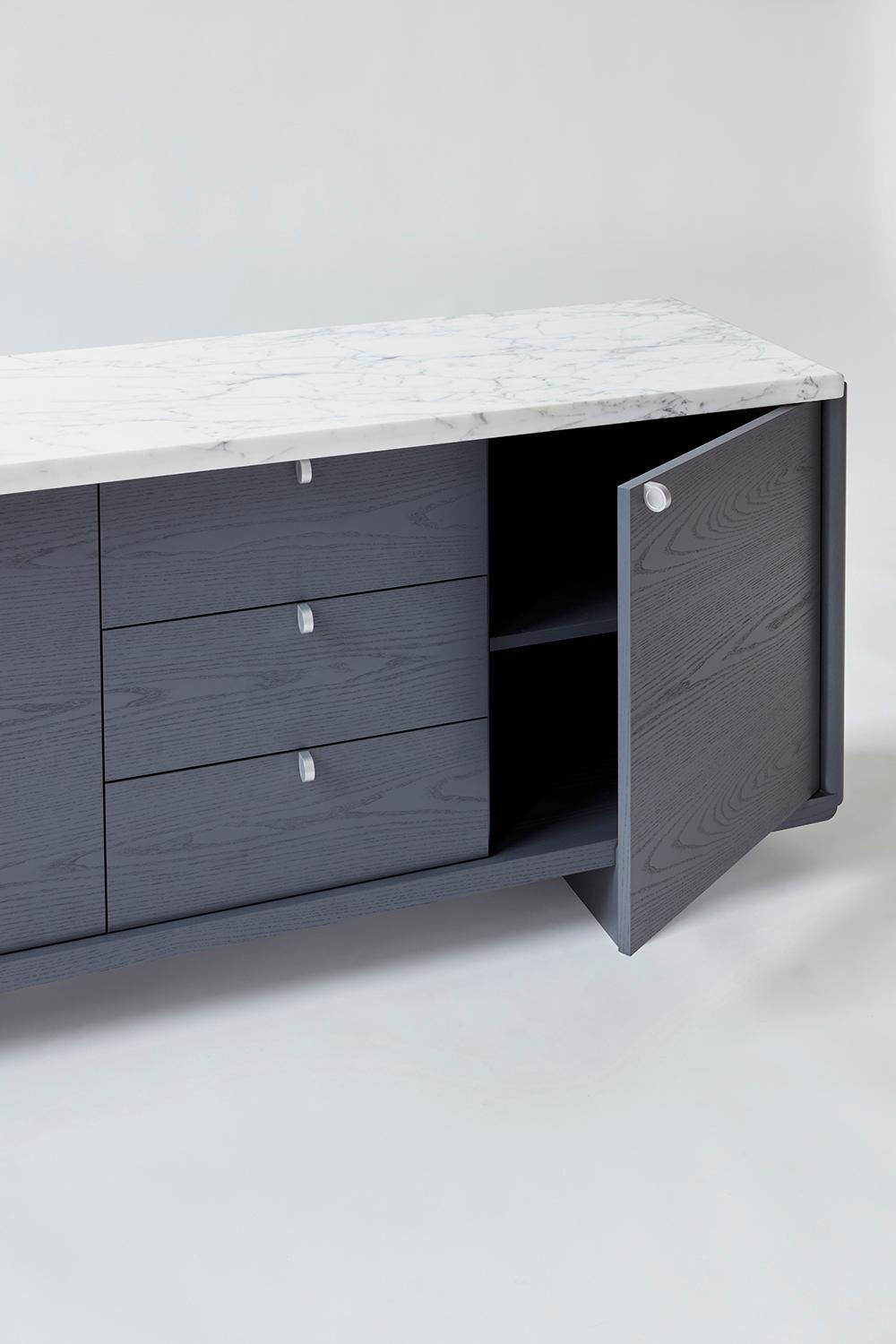 Nocturne credenza with slate lacquer finish and Calacatta marble. The newest edition in our Nocturne series of case pieces, utilizing a considered material pallet of Calacatta marble, solid ash with a slate lacquer finish and brushed/waxed aluminum,