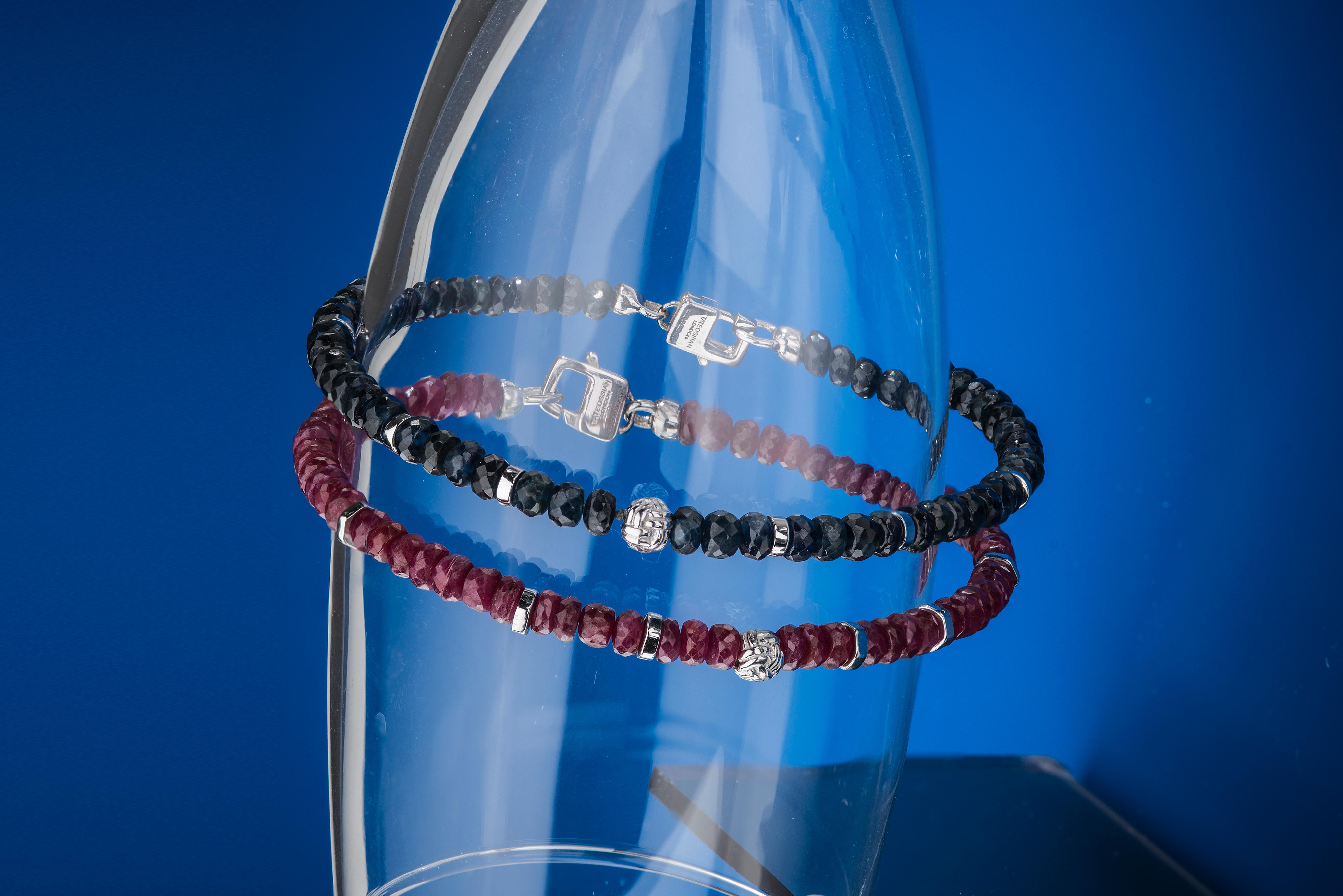 Tateossian continues to explore and find beauty in rare and less traditional precious stones. This hand strung beaded bracelet are made up of  precious Rubies faceted rondels, silver discs, a central silver knot bead and our signature Tateossian