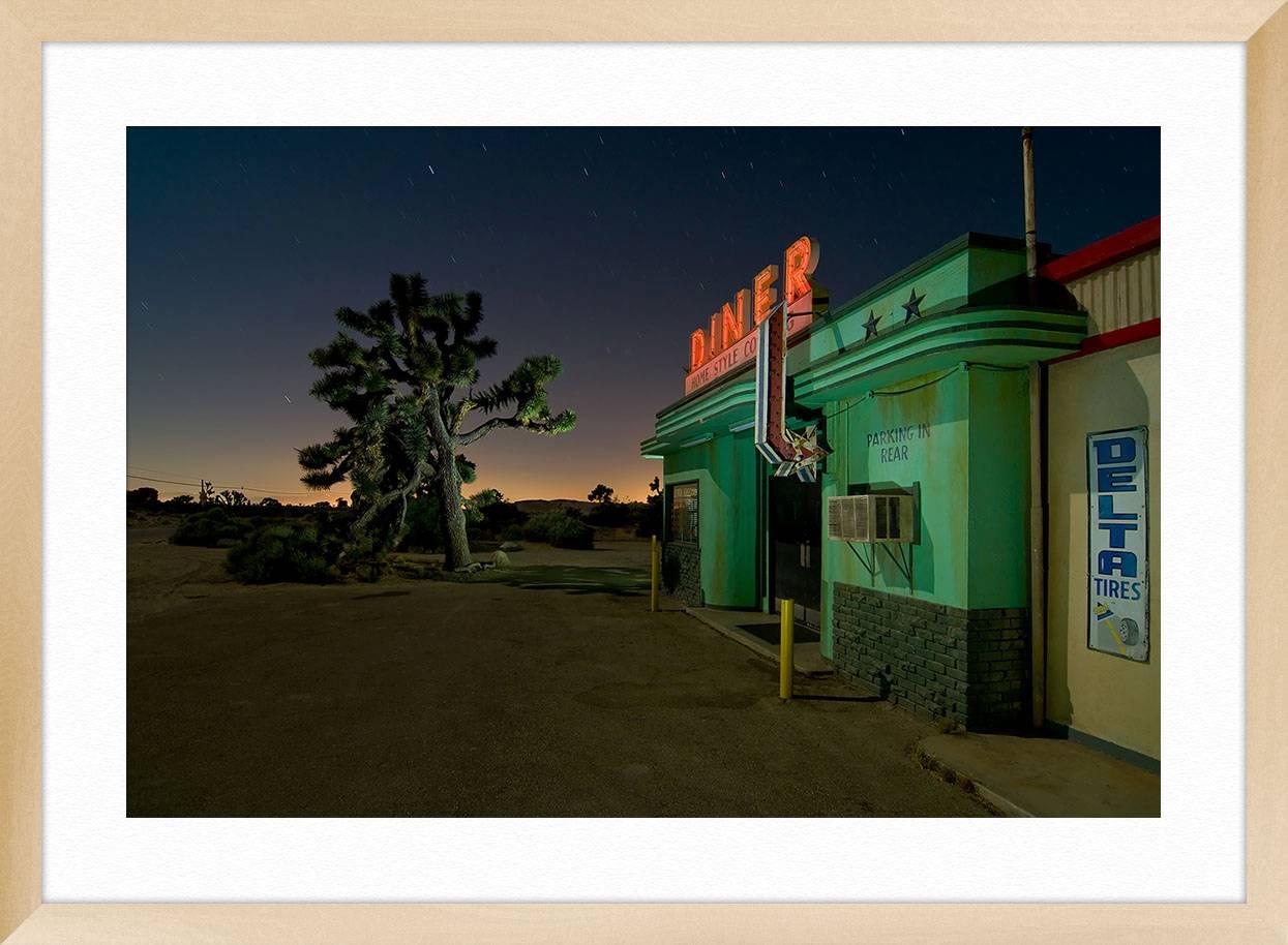 ABOUT THIS PIECE: This photograph is of a movie set diner and Joshua tree lost in the desert near a place called Lake Los Angeles, California.

ABOUT THIS ARTIST: Noel Kerns is a Texas-based photographer who specializes in capturing the abandoned
