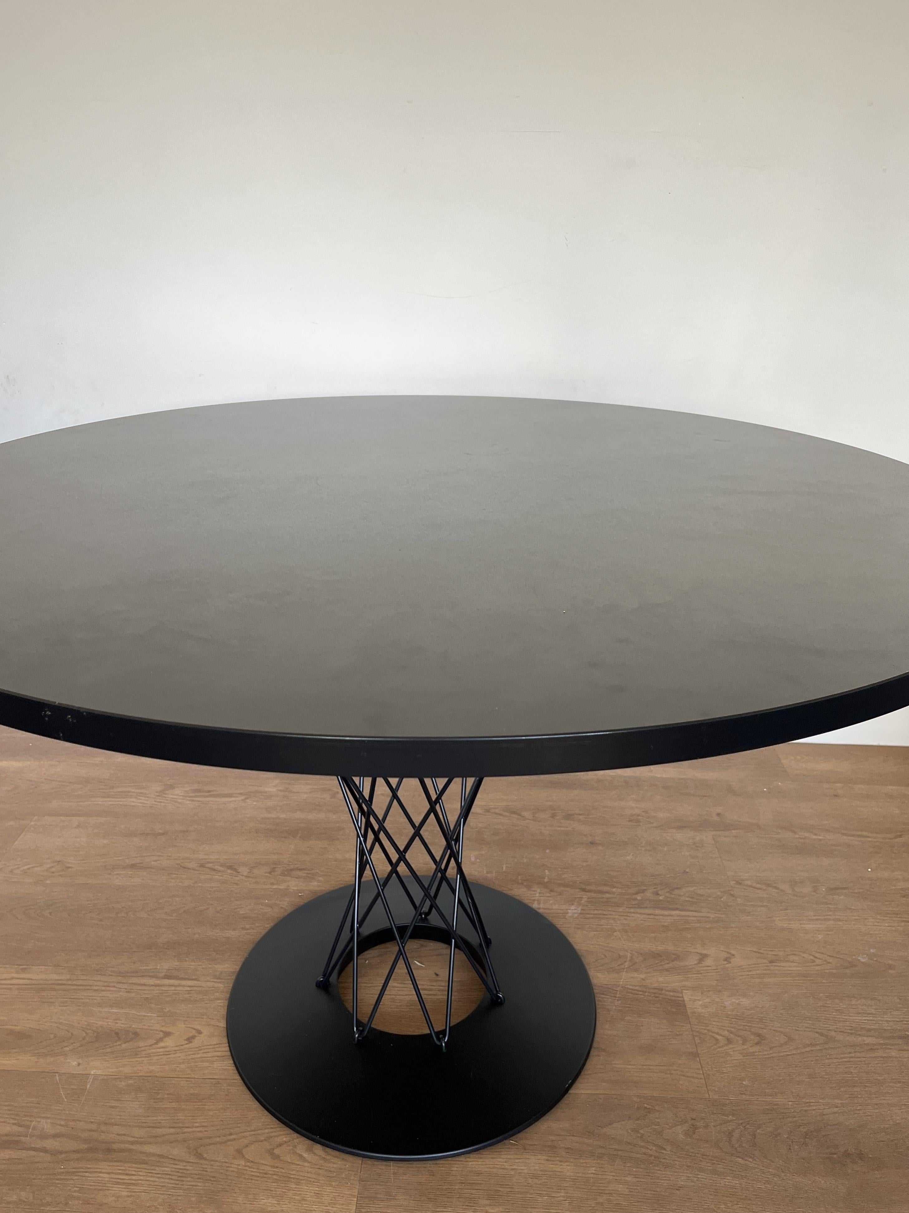 Dining table designed by Isamu Noguchi for Vitra

The table has an black laminate top with a black cast iron base and chromed steel rod supports. The 'all black;' top was a special limited edition when it was ordered by the previous owner in