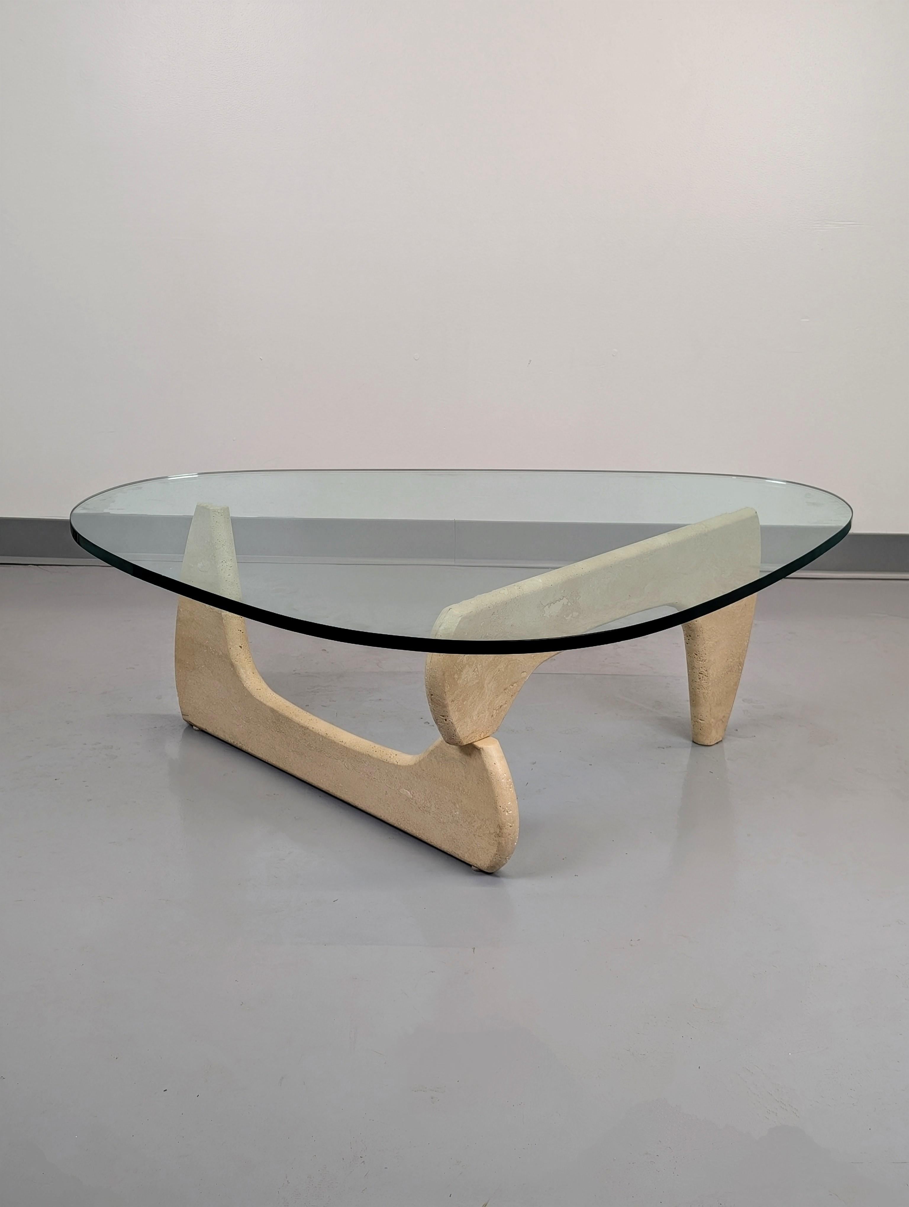 An unusual and uncommon example of the classic IN-50 coffee table design by Isamu Noguchi. The base is well executed and quality constructed travertine having a similar form as the IN-50. Heavy base comes apart into two mirror pieces. Thick and high
