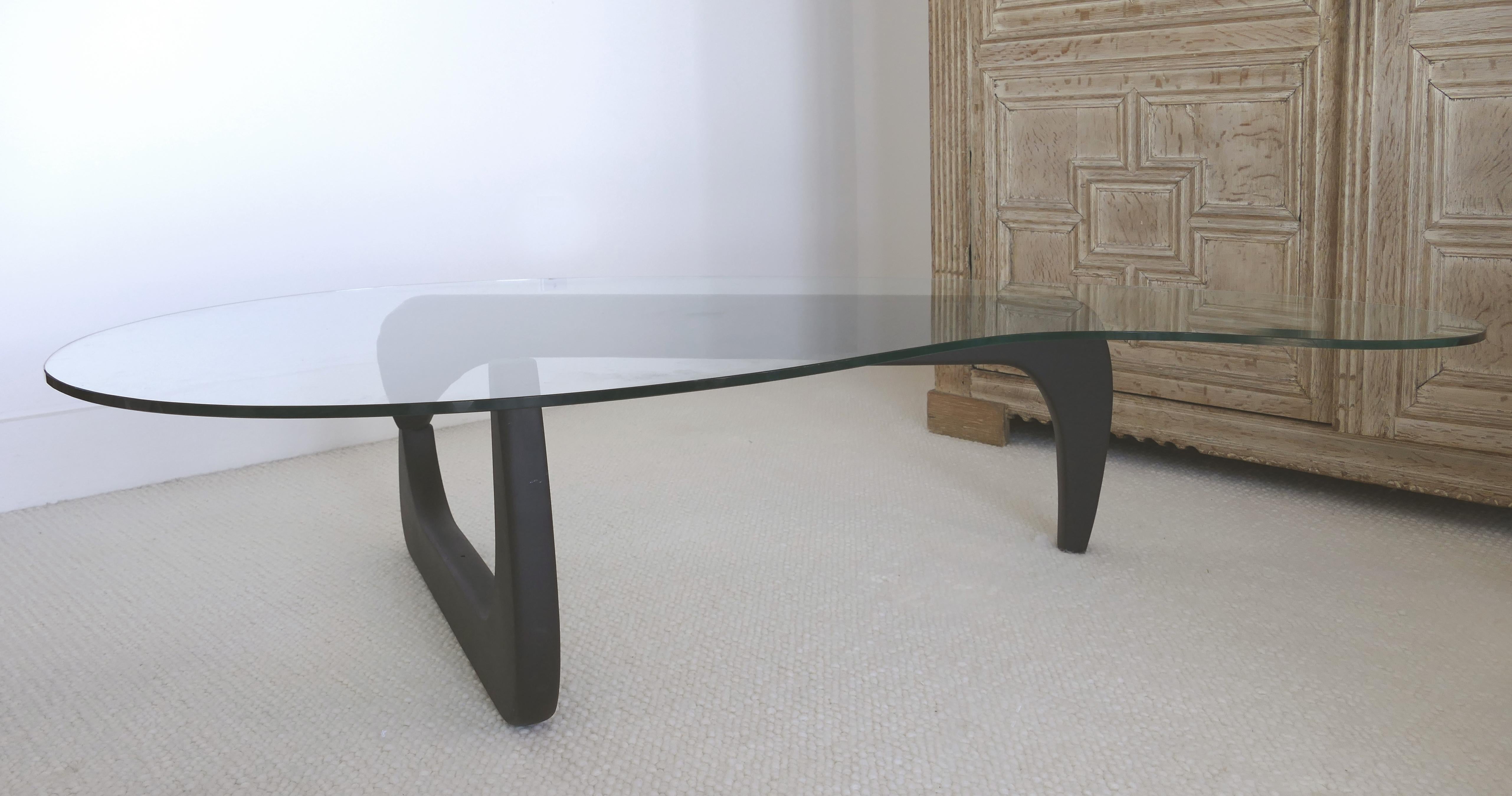 Noguchi style coffee table with amoeba shaped glass top

Offered for sale is a coffee table created in the Noguchi style with an amoeba-shaped glass top. This table is an over scale version of the original with an extended articulated wood base