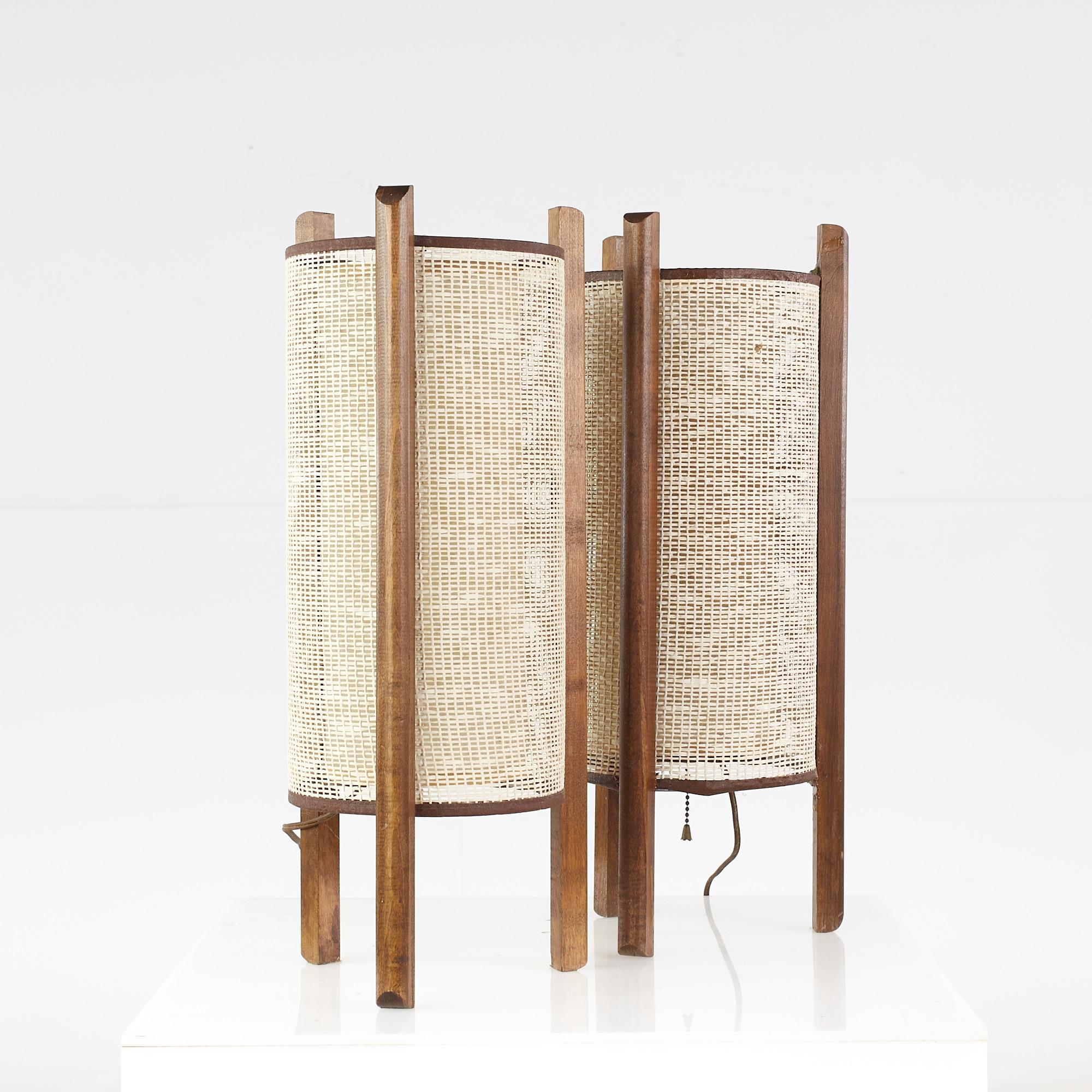 Noguchi style mid-century cylinder lamps - pair.

Each lamp measures: 8 wide x 8 deep x 20 inches high.

Good vintage condition. Scuffs to wood, insignificant holes in rattan, dried glue spot on one.

We take our photos in a controlled