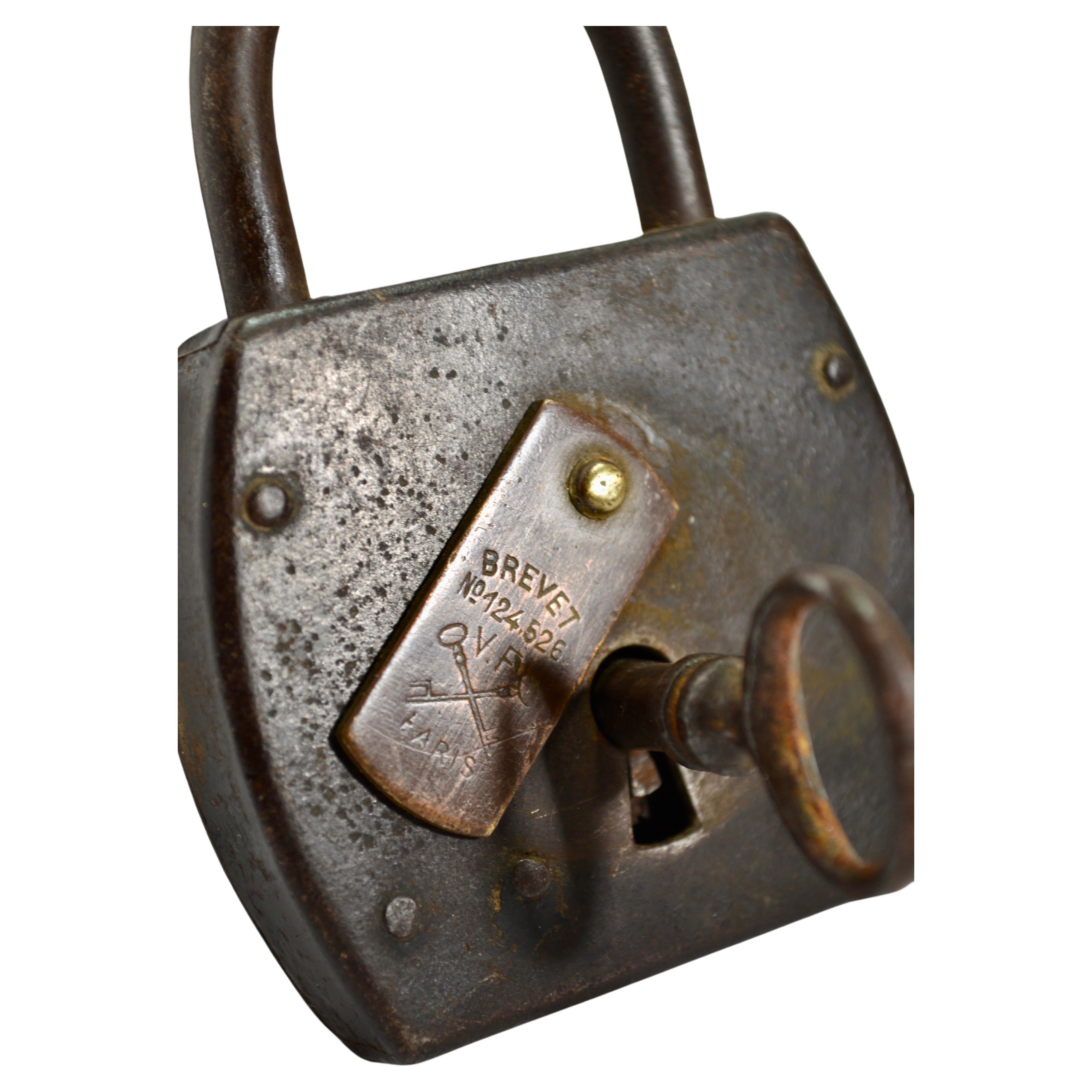 Antique large padlock accompanied by its original functional skeleton key.





