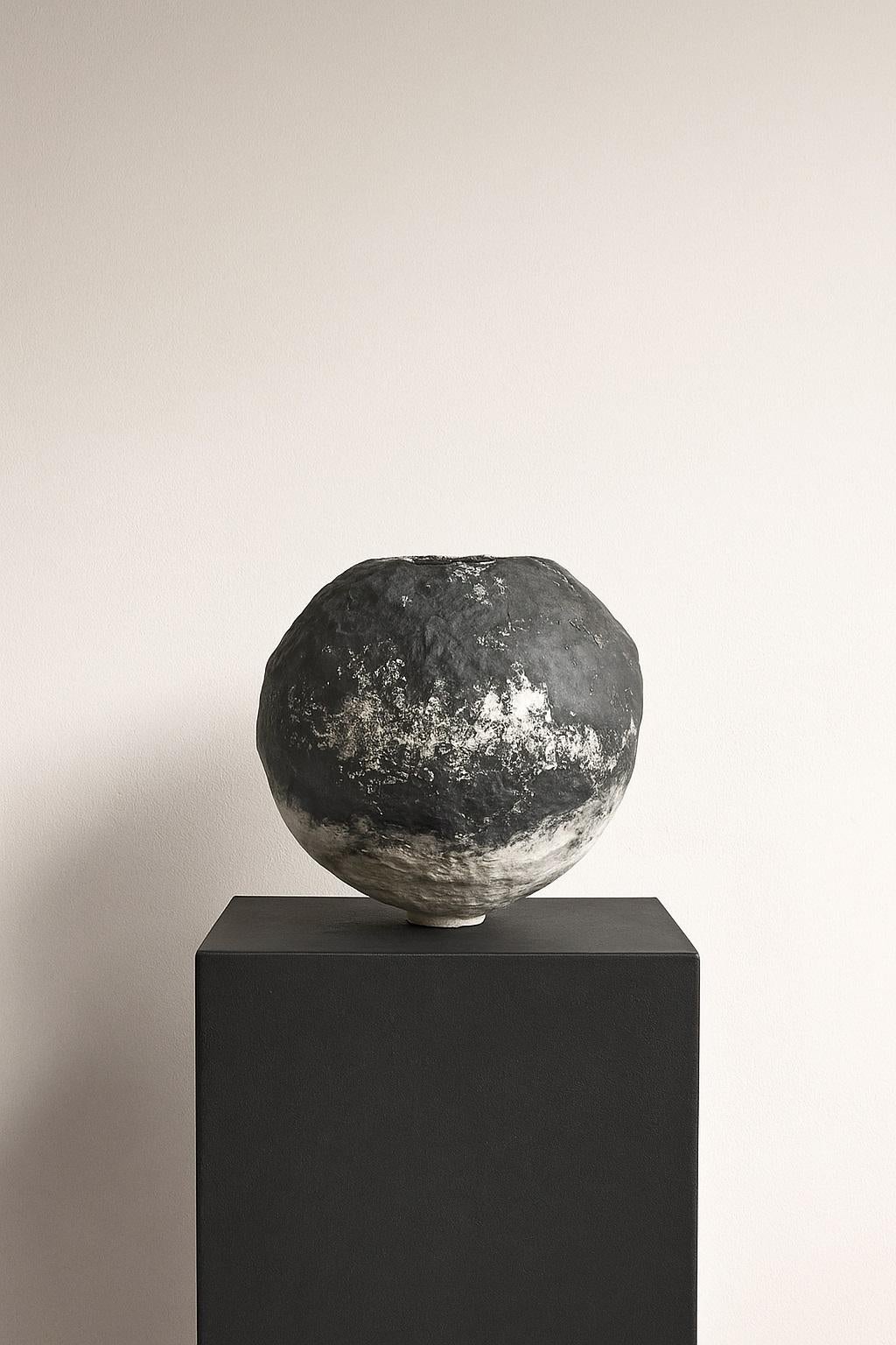 An ode to contrast and quiet drama, the Noir Grecian Vessel by Maison Lamiè is a sculptural meditation on form, texture, and antiquity reimagined. Crafted by hand in 2025 using Maison Lamiè’s proprietary mix of clay, paper, and plaster, this