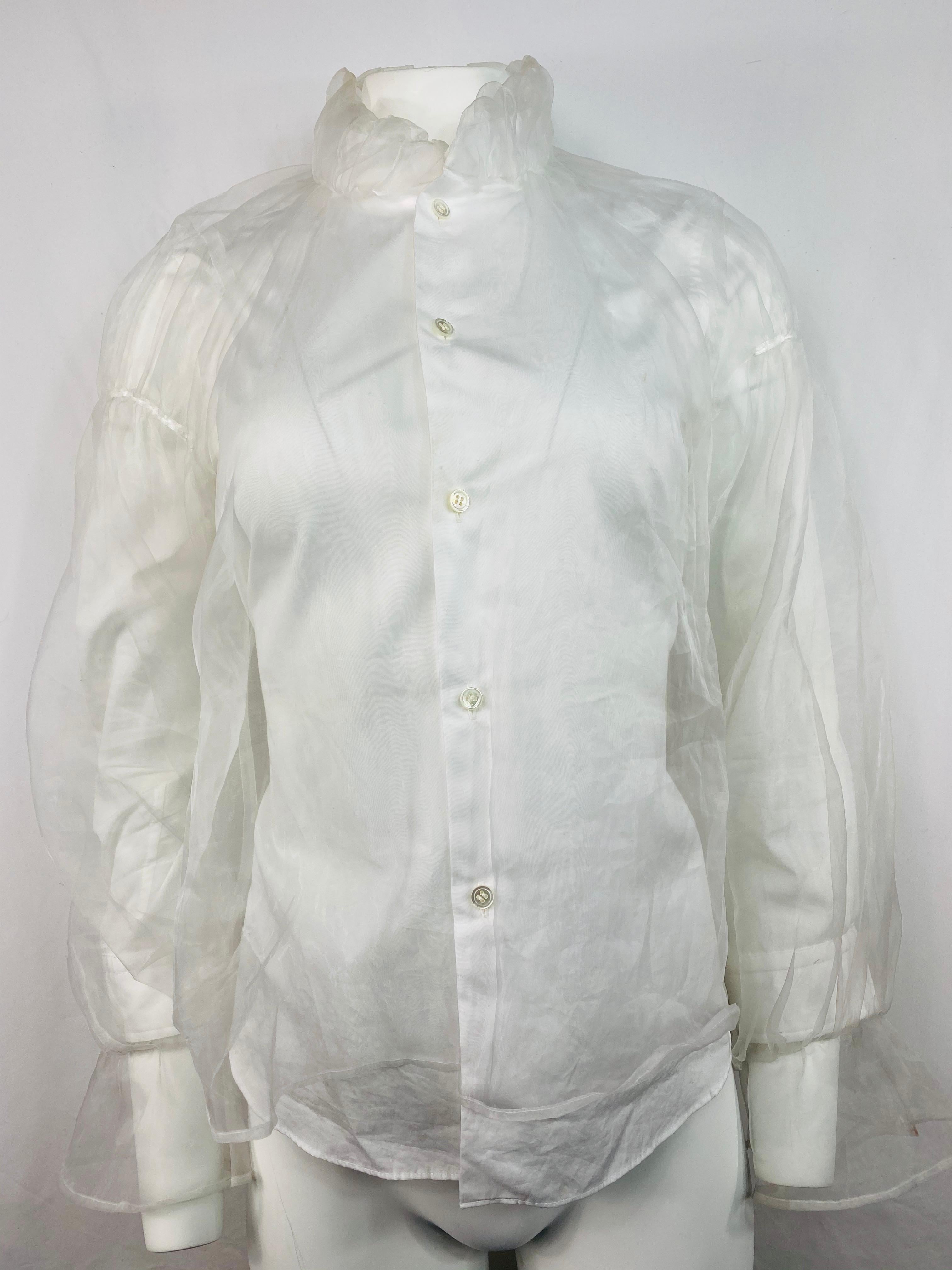 Produxt details:

White see through button down shirt with white under shirt at the front and sleeves that ties on the back. Featuring ruffled collar and flare designed sleeves detail on the bottom.
Made in Japan.